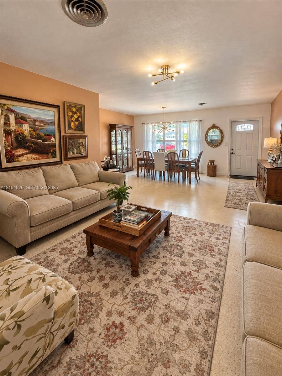 Open-concept living area with smooth ceilings and neutral wall tones