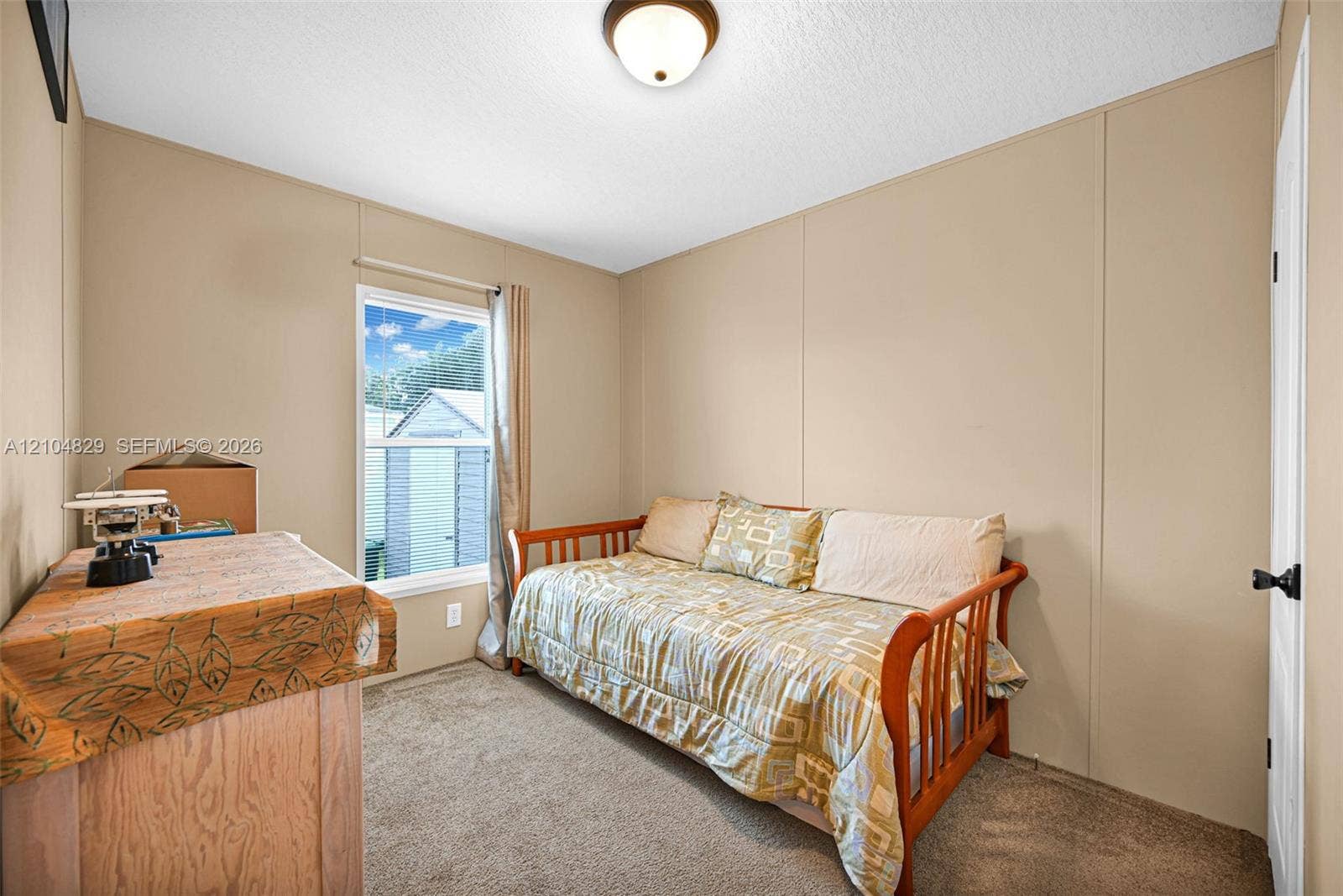 1880 SW 83rd Terrace, Davie, FL 33324 Neutral-toned wall panels, carpeted flooring, single-pane window, and a centered flush-mount ceiling light fixture