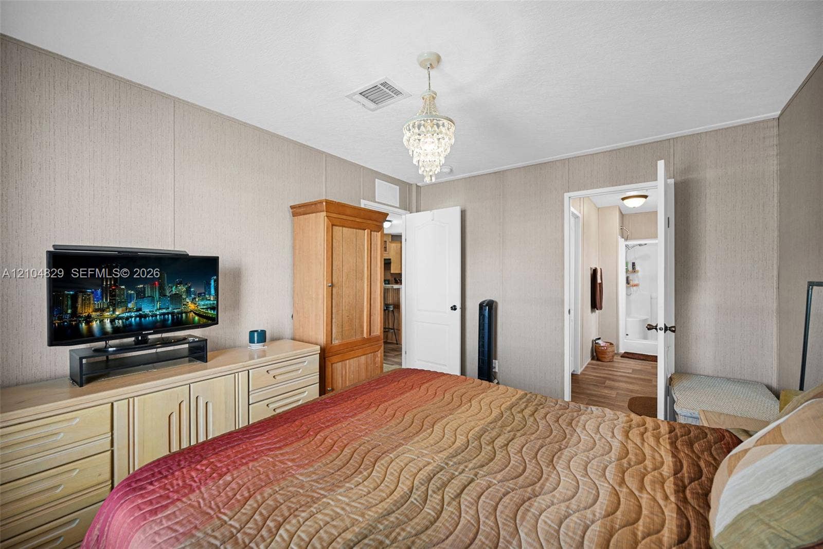 1880 SW 83rd Terrace, Davie, FL 33324 Neutral wall paneling, crystal-style chandelier, and solid-core interior doors