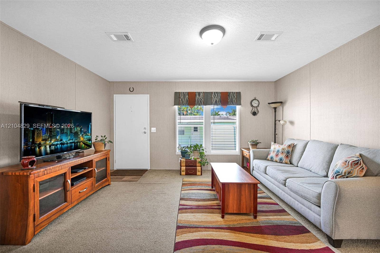 1880 SW 83rd Terrace, Davie, FL 33324 Neutral wall finishes, carpeting, and flush-mount ceiling lighting