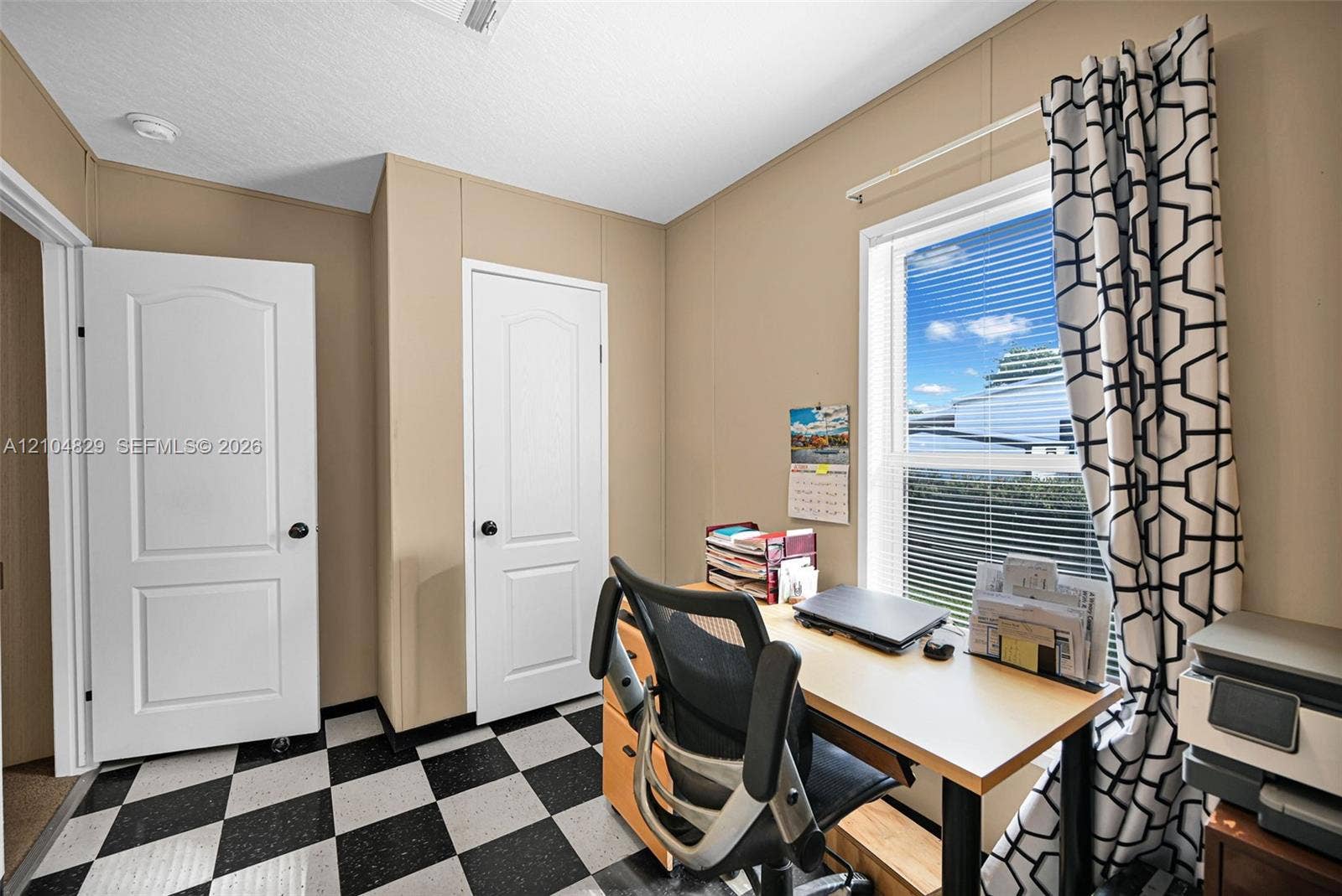 1880 SW 83rd Terrace, Davie, FL 33324 Room featuring a black and white checkered floor, two interior doors with arched top panels, and a single-hung window