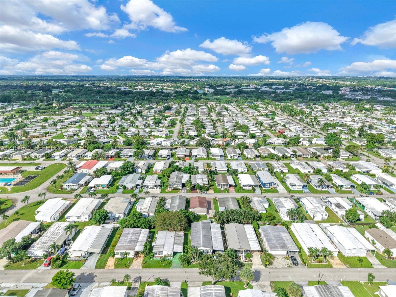 1880 SW 83rd Terrace, Davie, FL 33324 Aerial perspective of a planned community featuring paved streets, established landscaping, and a central outdoor recreation area