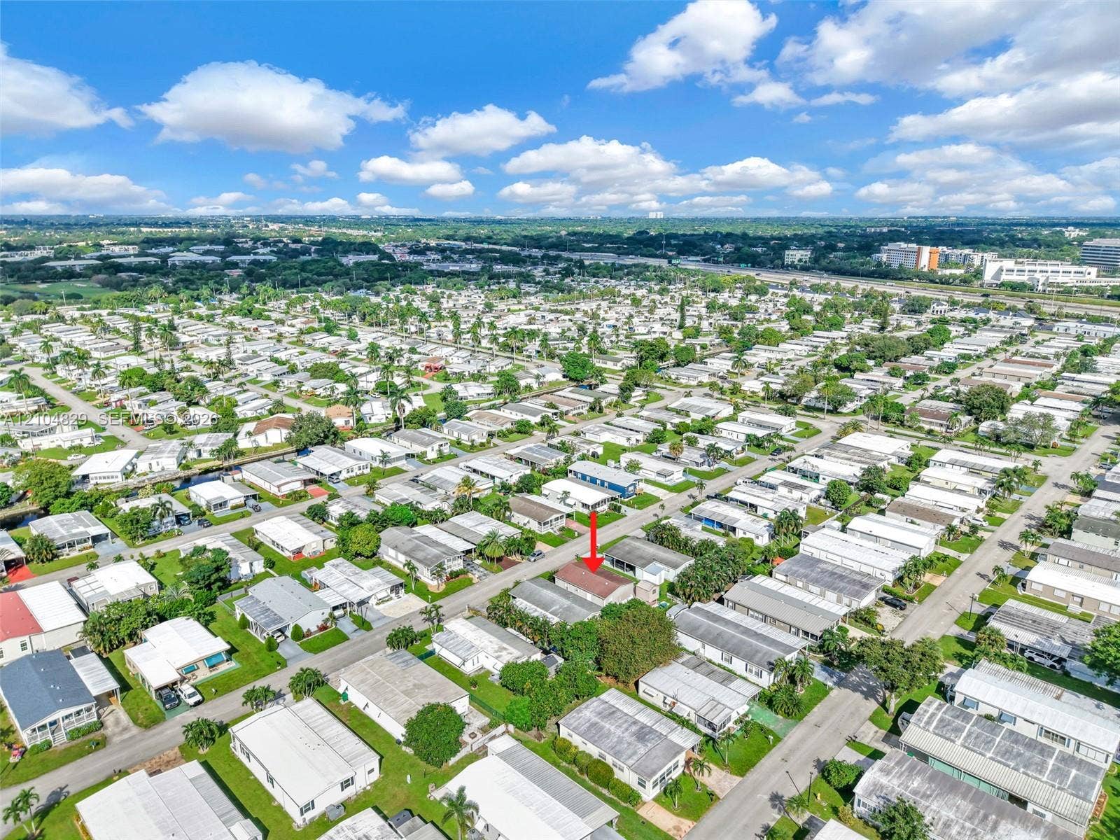 1880 SW 83rd Terrace, Davie, FL 33324 Aerial view of residential property featuring a rectangular-shaped lot with mature trees and paved street access