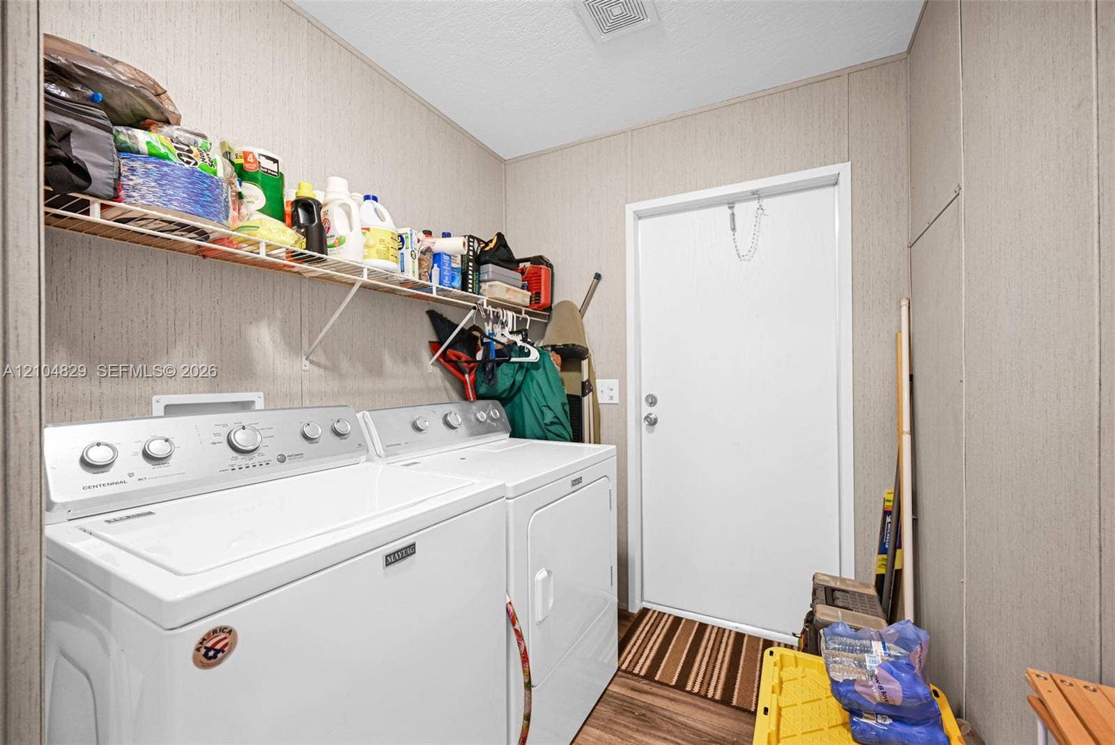 1880 SW 83rd Terrace, Davie, FL 33324 Utility area featuring built-in wire shelving and wood-finish flooring
