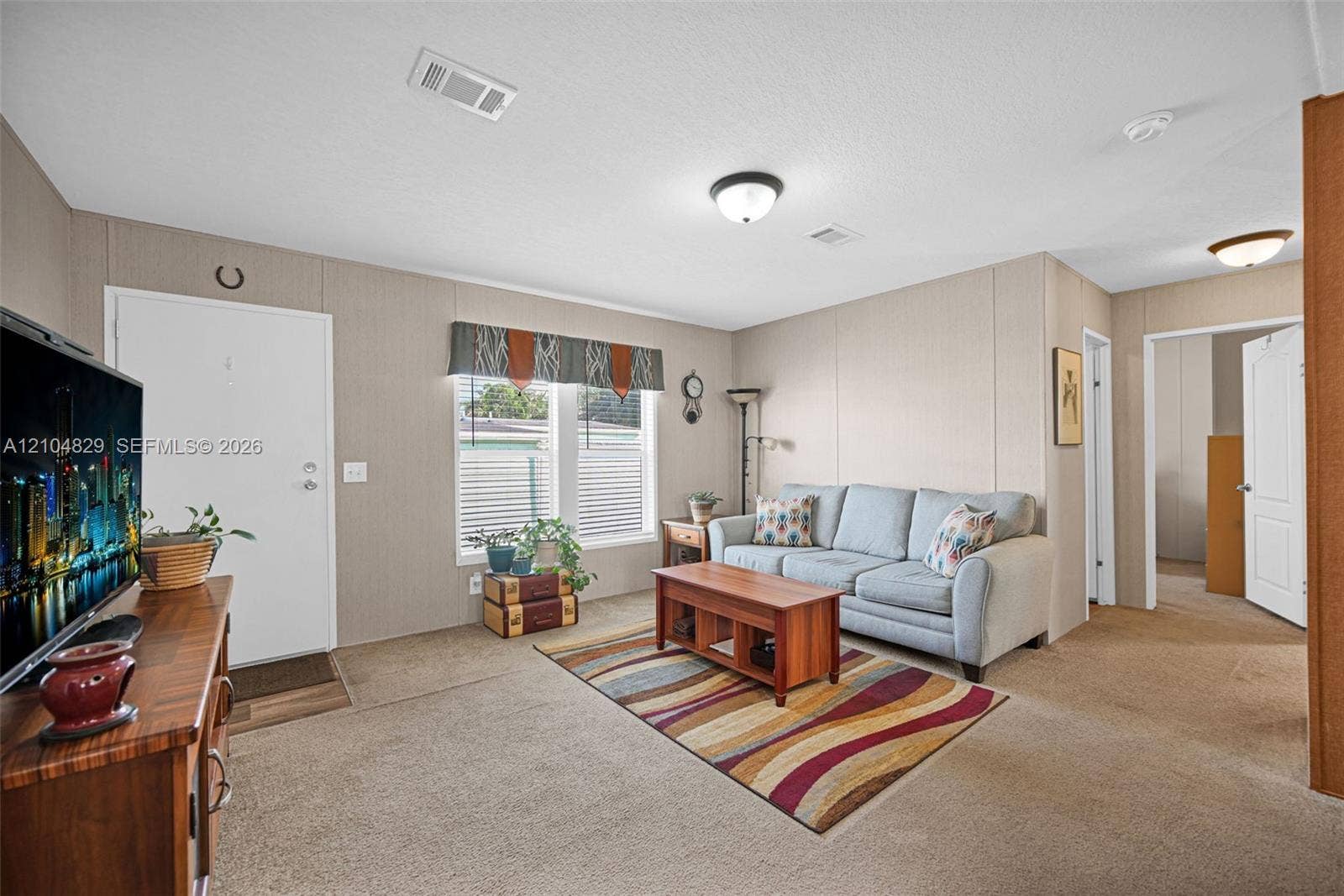 1880 SW 83rd Terrace, Davie, FL 33324 Exterior storage structure featuring exposed timber framing, white paneled walls, plywood flooring, integrated wall-mounted shelving, and a single window