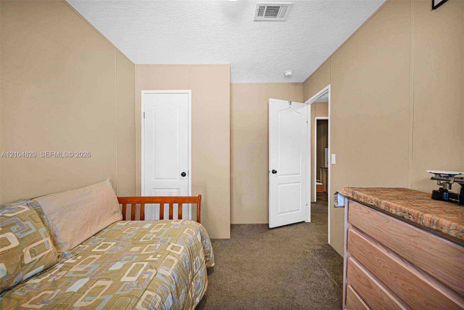 1880 SW 83rd Terrace, Davie, FL 33324 Neutral-toned interior walls featuring panel doors with matte black hardware and carpeted flooring