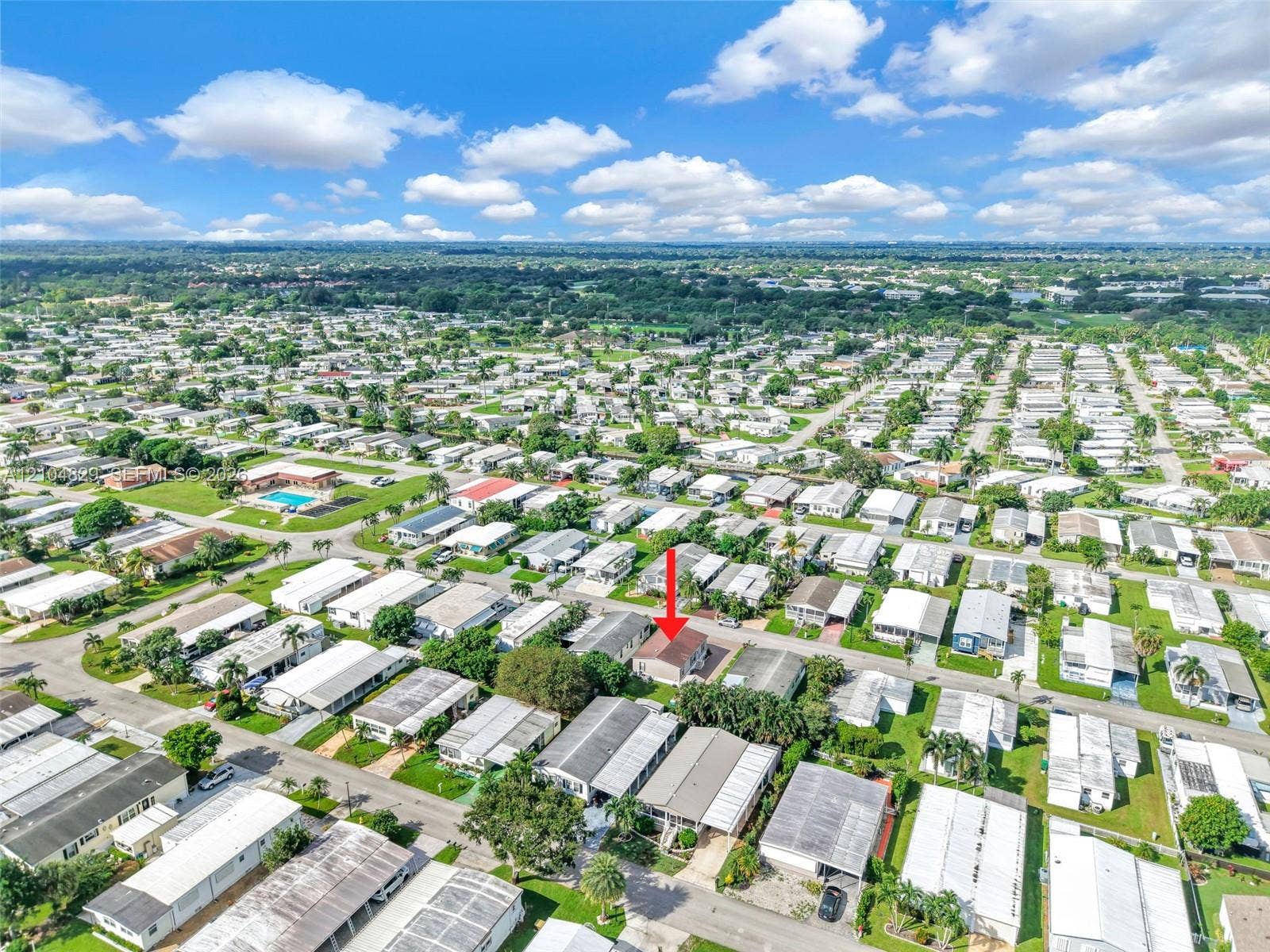 1880 SW 83rd Terrace, Davie, FL 33324 Aerial view of a residential property situated in a suburban community, featuring established greenery and paved streets