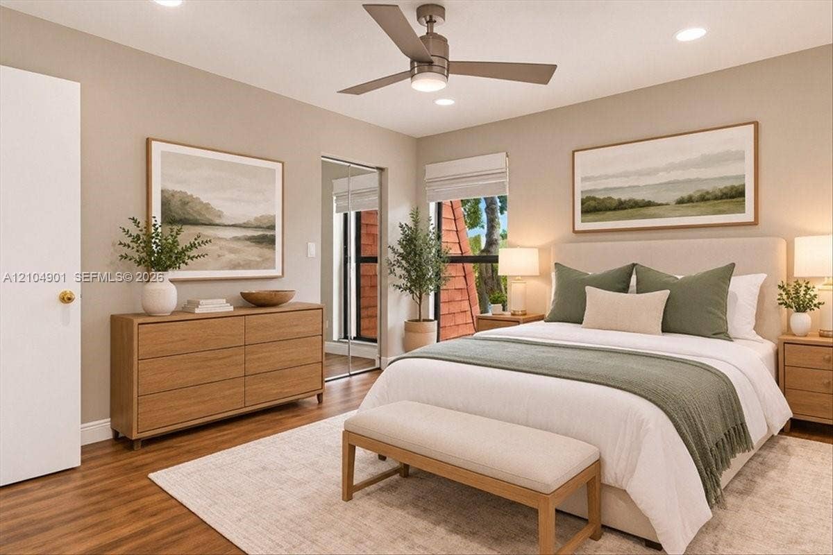 Neutral-toned interior featuring wood-finish flooring, recessed lighting, a modern ceiling fan, and sliding mirrored closet doors