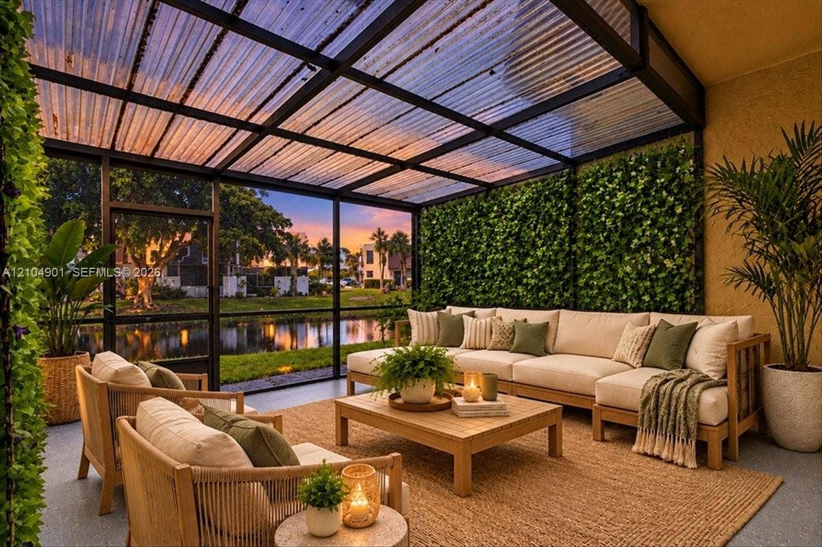 Enclosed patio featuring a black metal frame, corrugated translucent roofing, and vertical green wall accents
