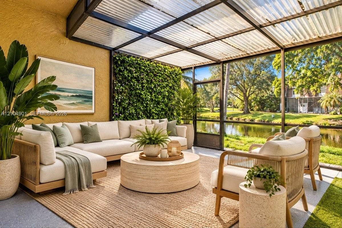 Screened-in patio featuring a corrugated translucent roof, a vertical garden wall, and concrete flooring