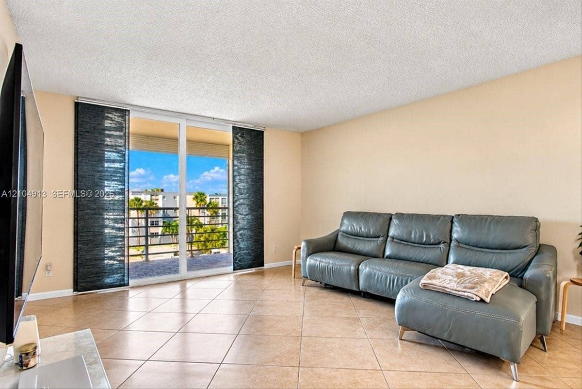 501 E Dania Beach Boulevard, #5-4A, Dania, Dania Beach, FL 33004 Living area featuring tile flooring, sliding glass doors, and a private balcony