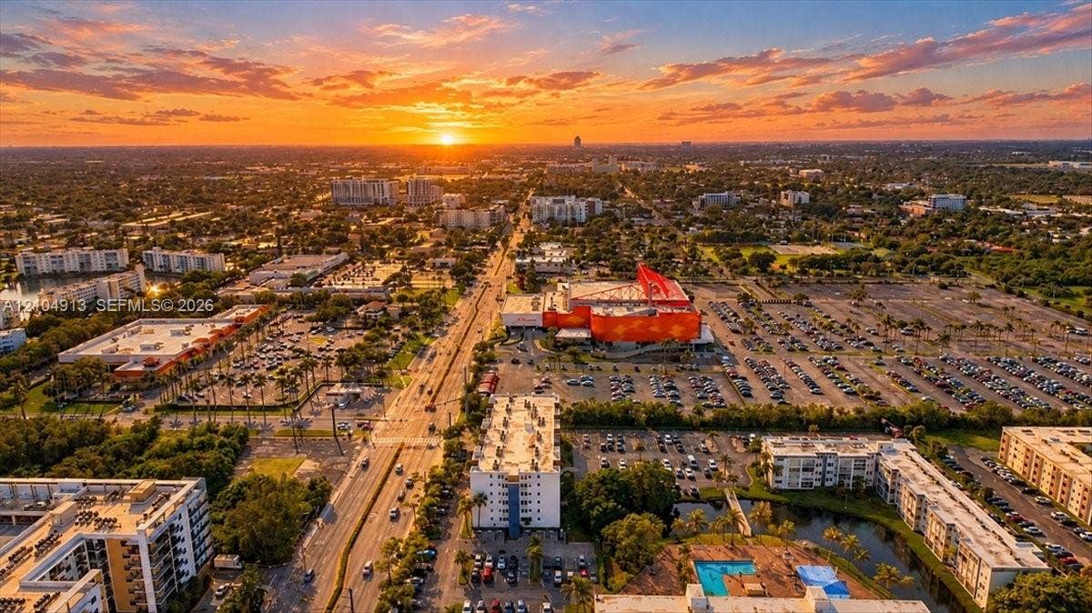 501 E Dania Beach Boulevard, #5-4A, Dania, Dania Beach, FL 33004 Aerial perspective featuring a prominent sunset backdrop over an expansive urban landscape with dense vegetation and established street infrastructure