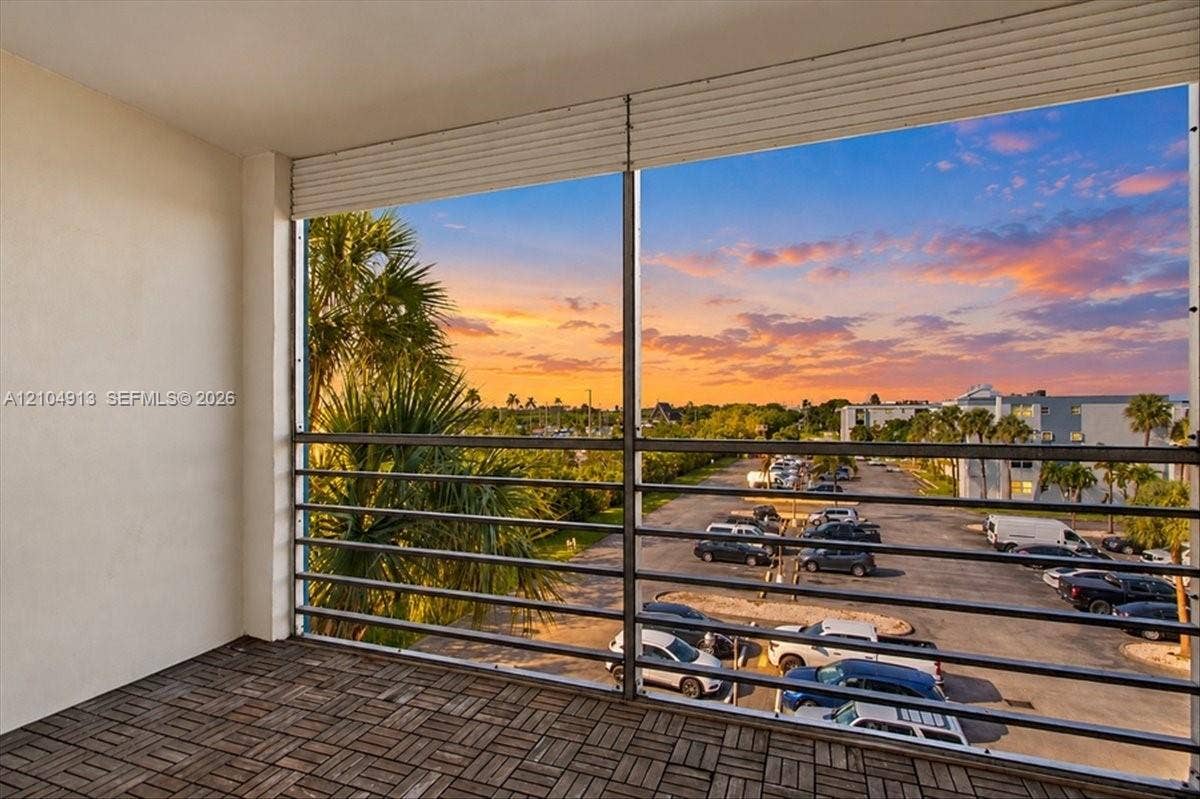 501 E Dania Beach Boulevard, #5-4A, Dania, Dania Beach, FL 33004 Covered balcony featuring wood-finish deck tiling and horizontal metal railing
