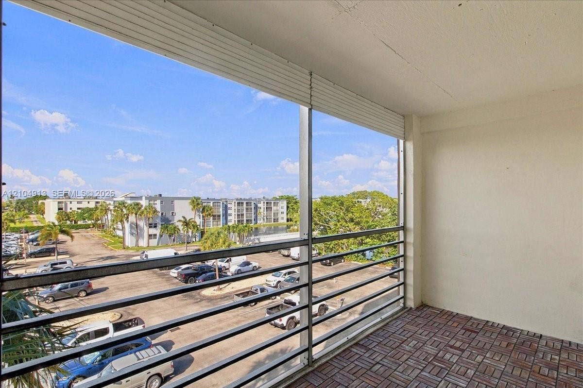 501 E Dania Beach Boulevard, #5-4A, Dania, Dania Beach, FL 33004 Screened-in balcony featuring metal railing and interlocking tile flooring
