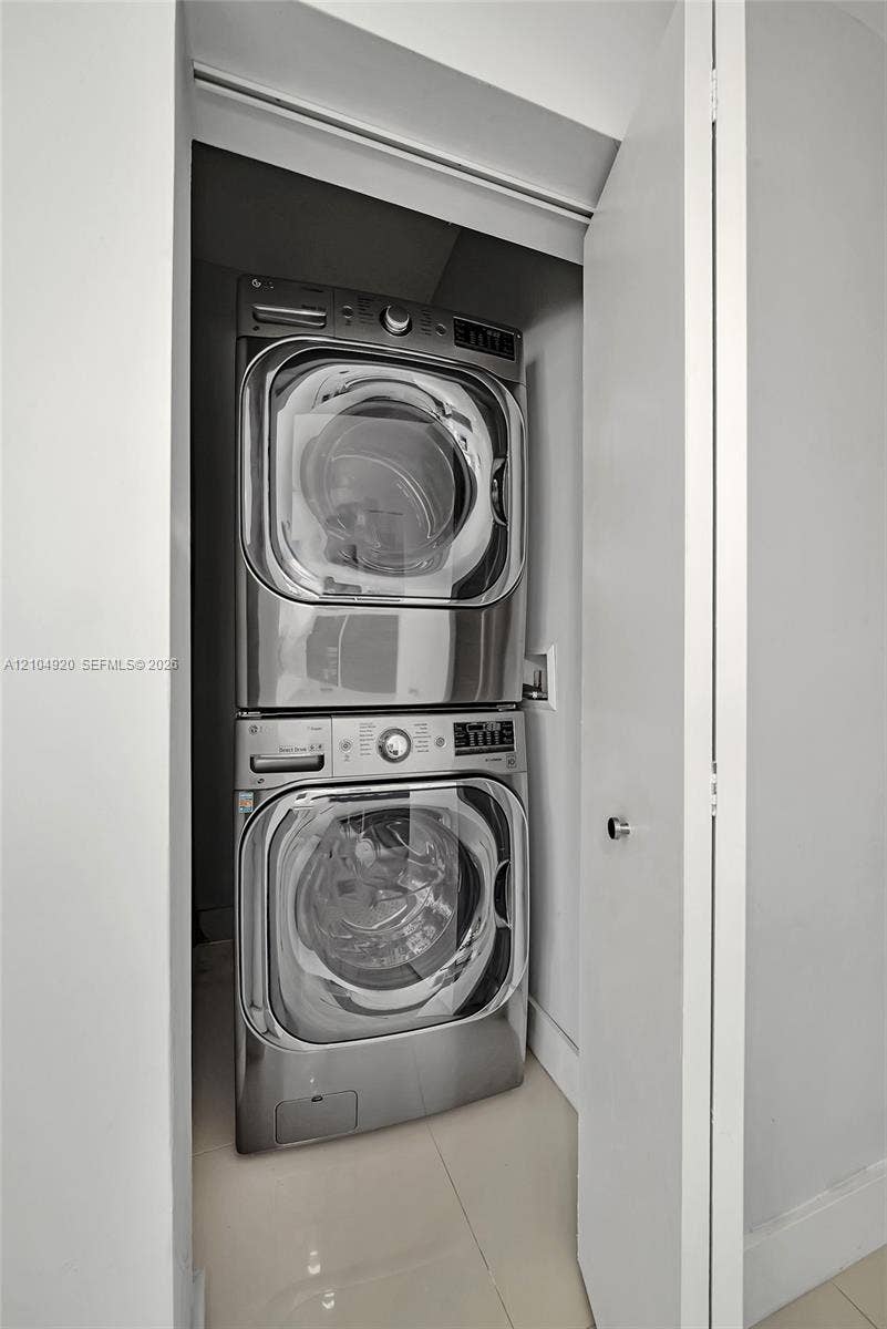 Closet housing a stackable stainless steel washer and dryer unit