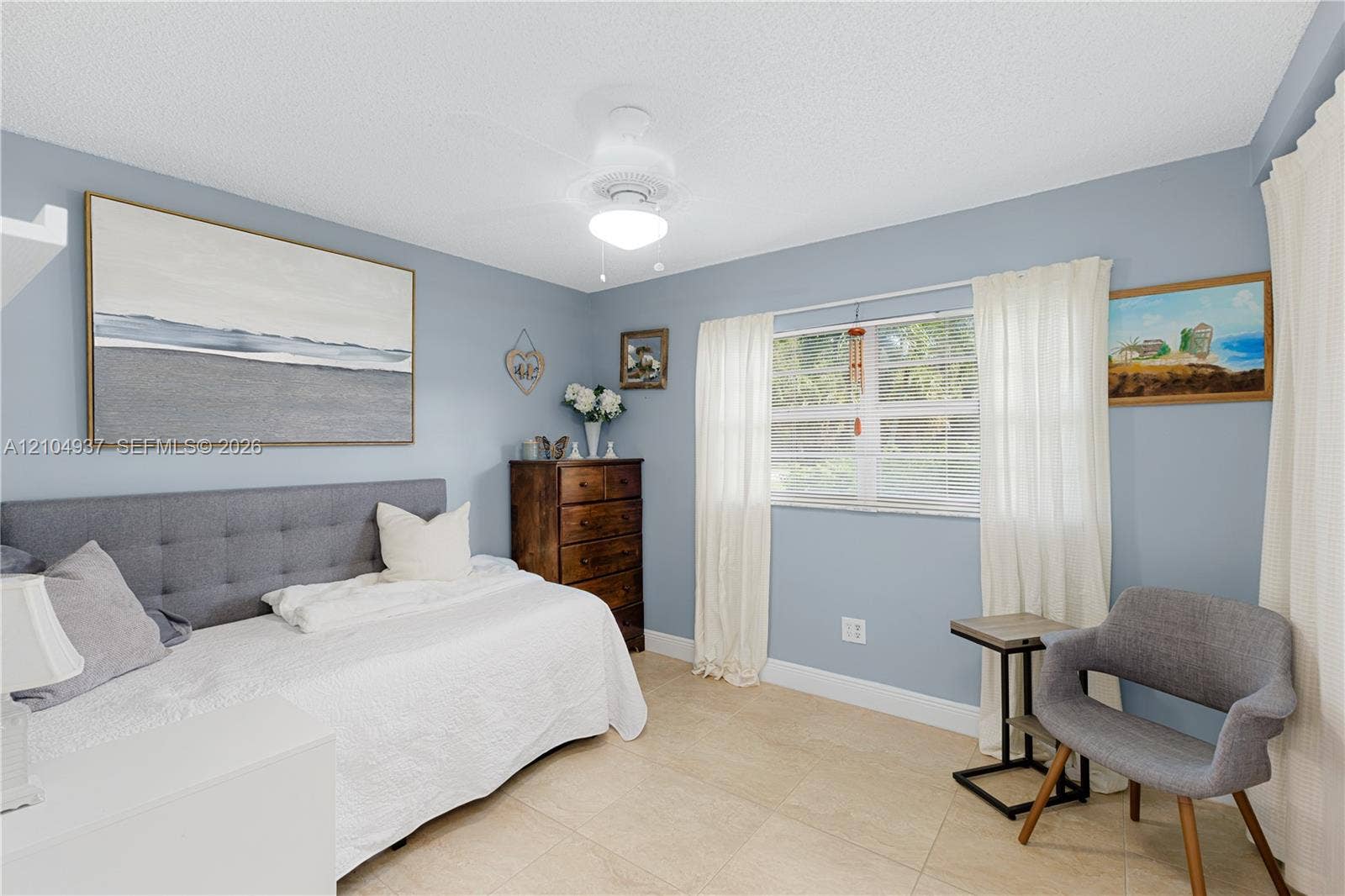 4108 NW 88th Avenue, #3, Coral Springs, FL 33065 Neutral-toned tile flooring, large multi-pane window, and central ceiling fan with integrated lighting