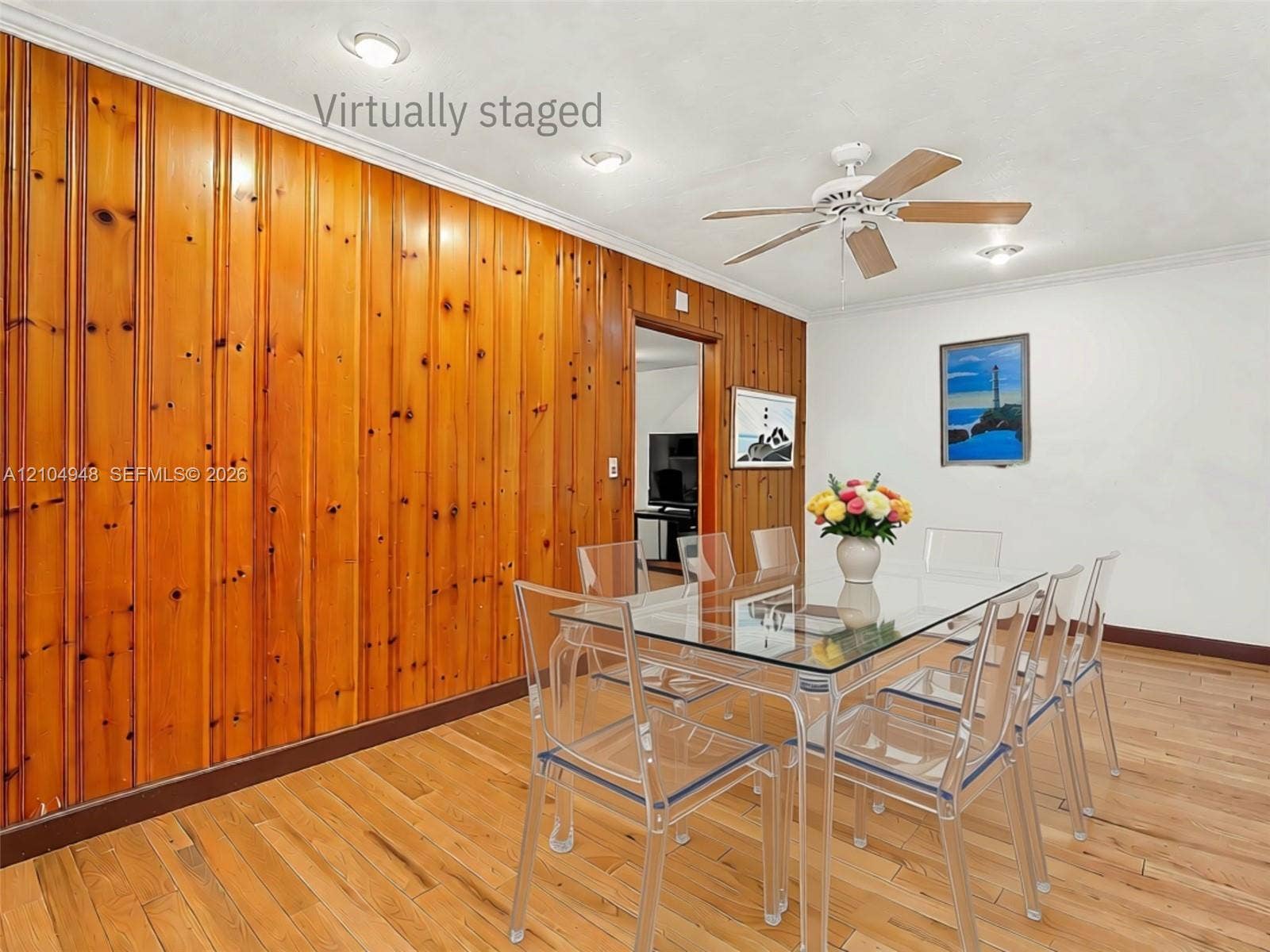 Wood paneling accent wall, hardwood flooring, recessed lighting, ceiling fan, crown molding