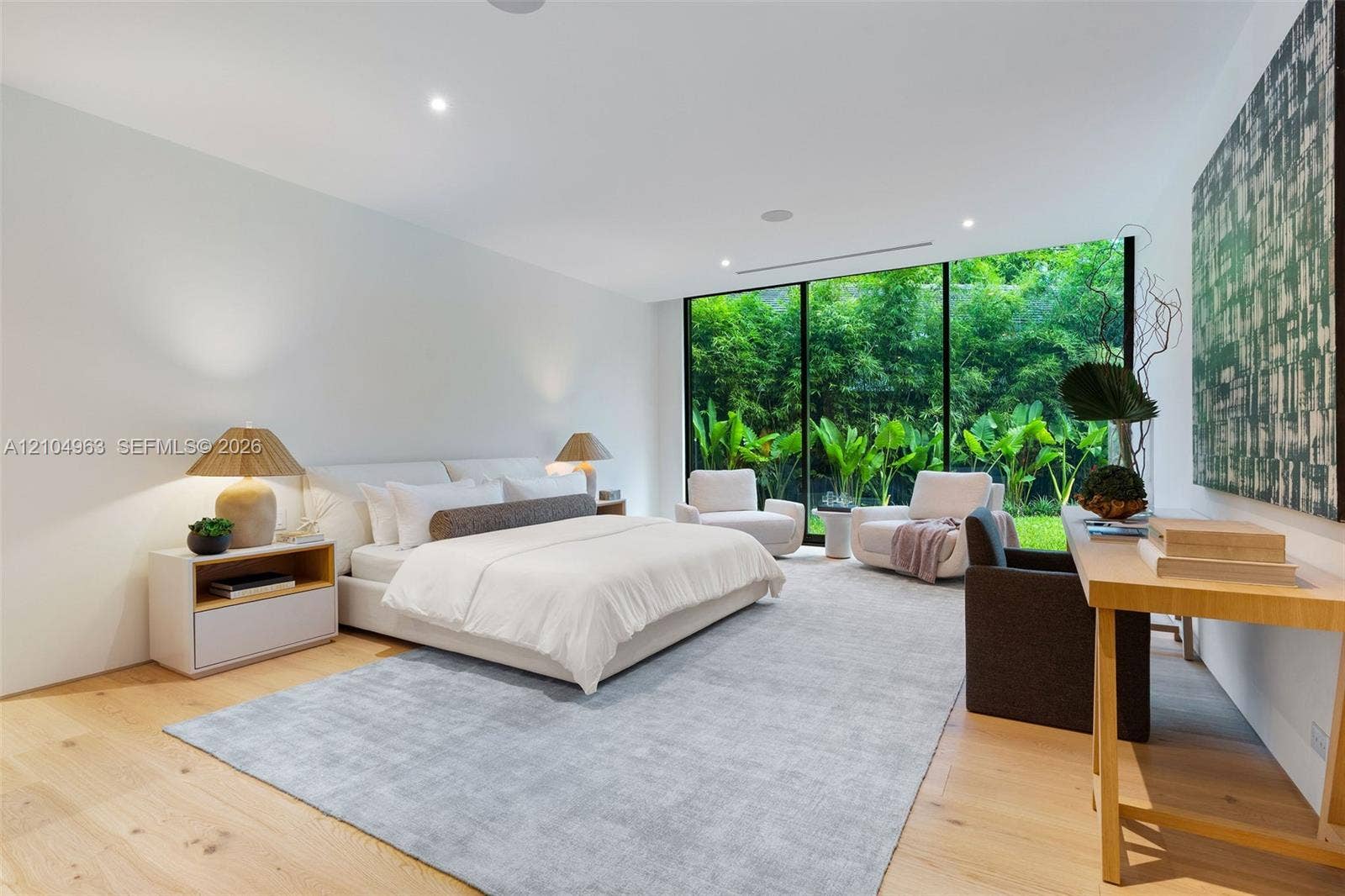 Floor-to-ceiling glass wall, light-toned wood-finish flooring, and recessed ceiling lighting