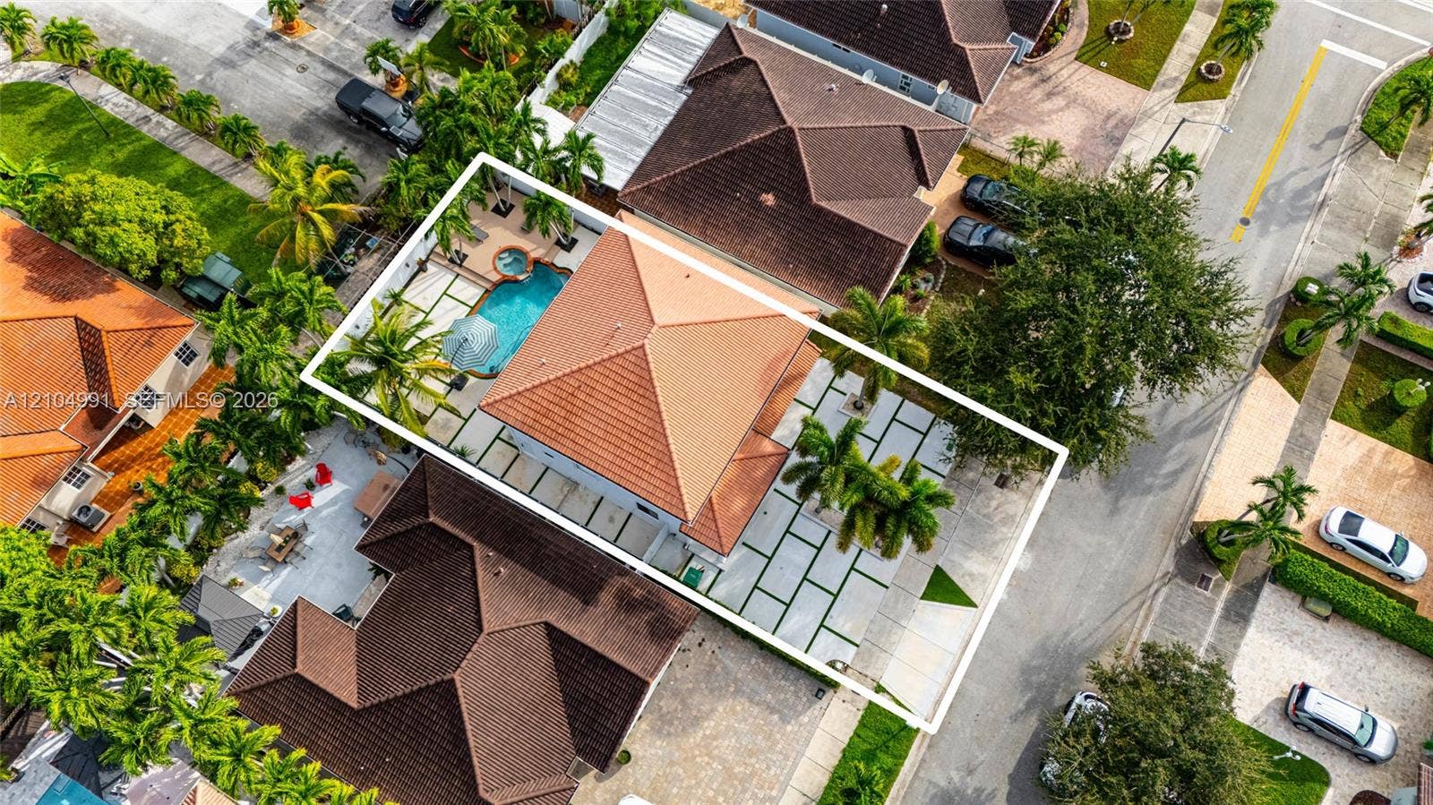 15217 SW 36th Terrace, #0, Miami, Miami, FL 33185 Aerial view featuring a tile roof, an in-ground swimming pool with an attached spa, and geometric concrete pavers