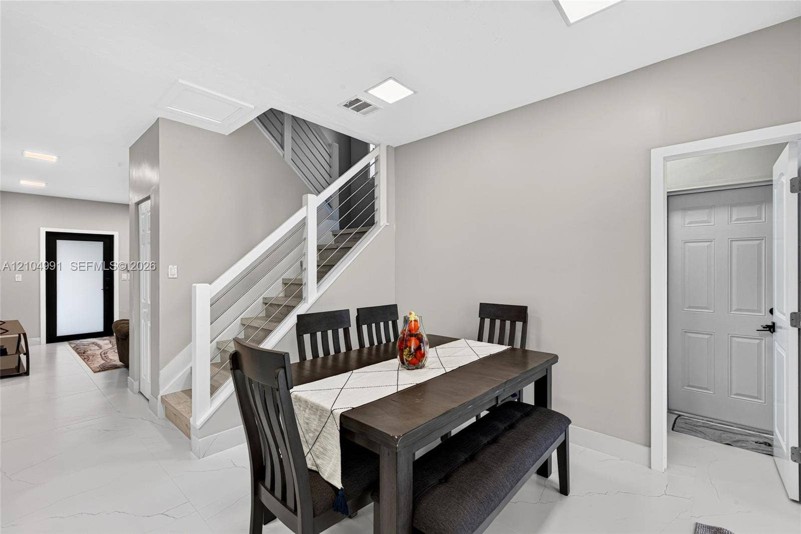 15217 SW 36th Terrace, #0, Miami, Miami, FL 33185 Staircase featuring a white handrail and horizontal wire balusters, light-toned large-format tile flooring, and recessed LED ceiling lighting