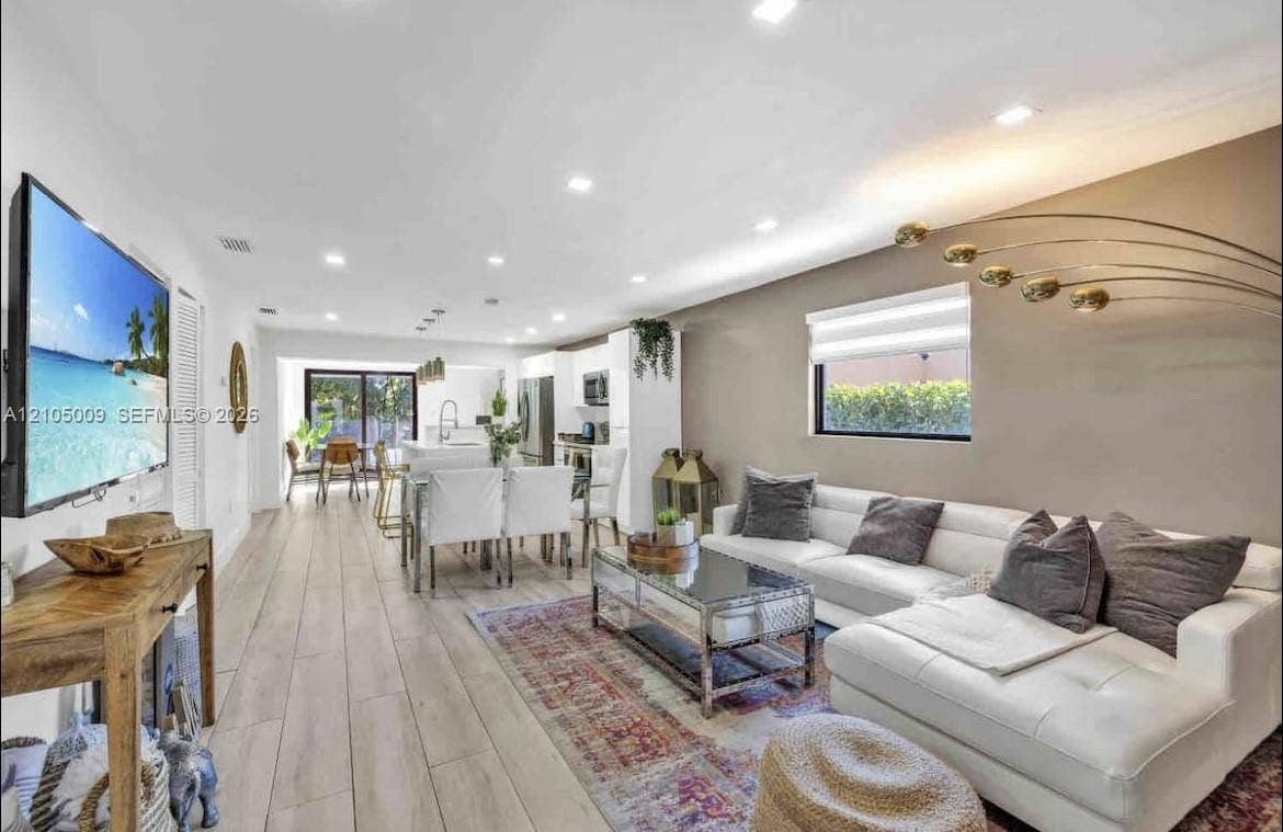 254 NW 51st Street, Miami, Miami, FL 33127 Open-concept living area featuring wood-finish flooring, recessed lighting, and a kitchen with stainless steel appliances