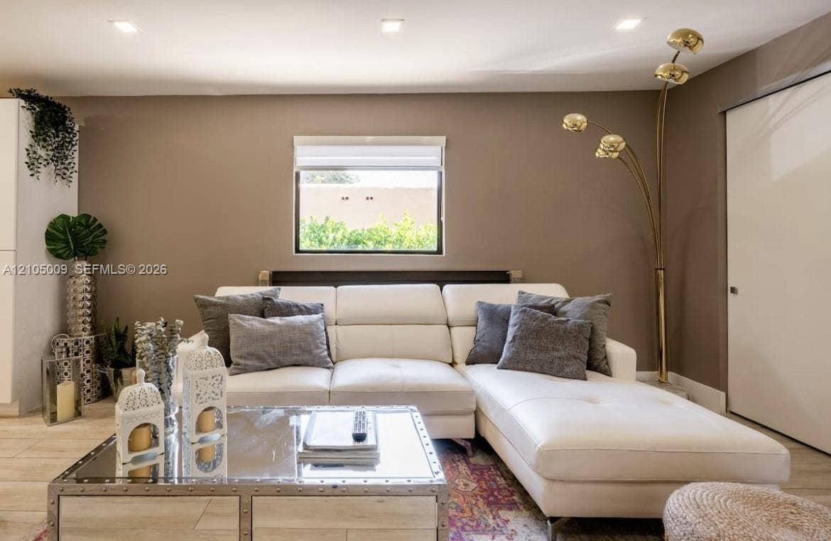 254 NW 51st Street, Miami, Miami, FL 33127 Recessed ceiling lighting, a single window with blinds, and light-toned walls create an inviting living space