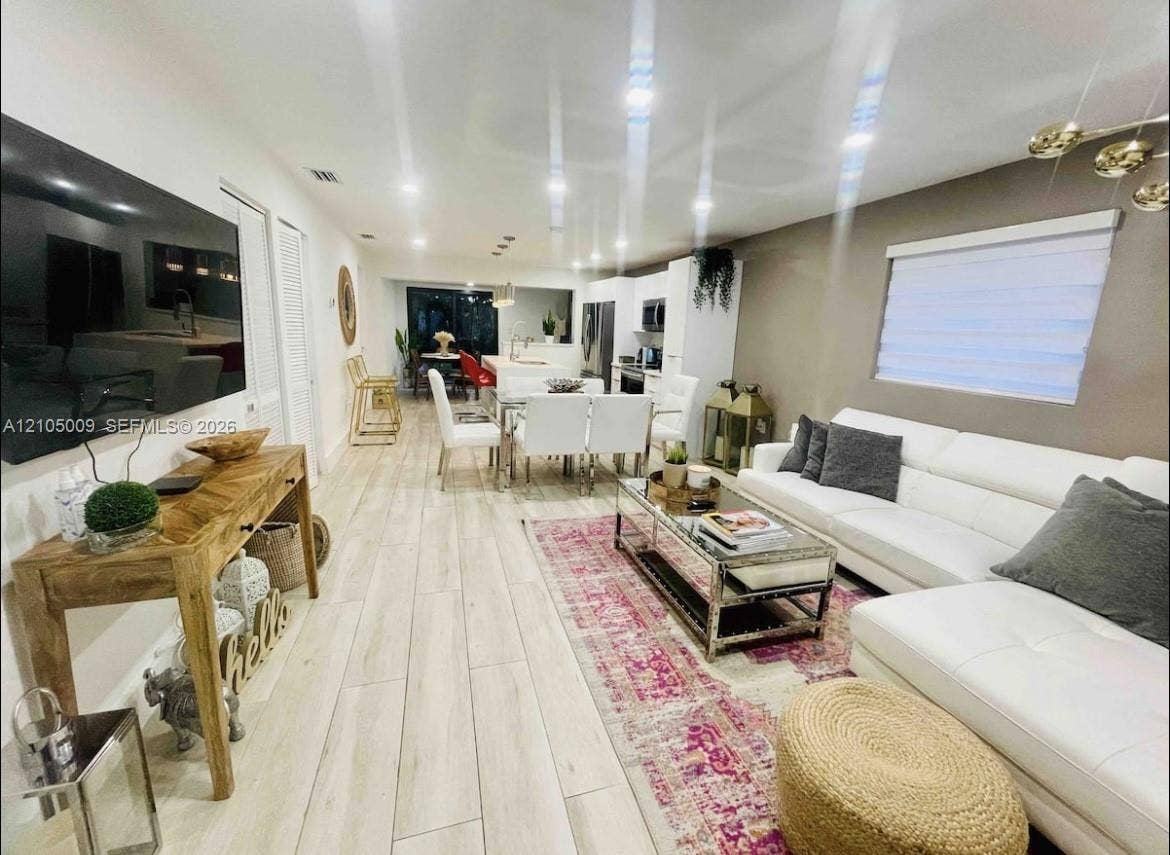 254 NW 51st Street, Miami, Miami, FL 33127 Open-concept living area with wood-finish flooring, recessed lighting, and a neutral color palette