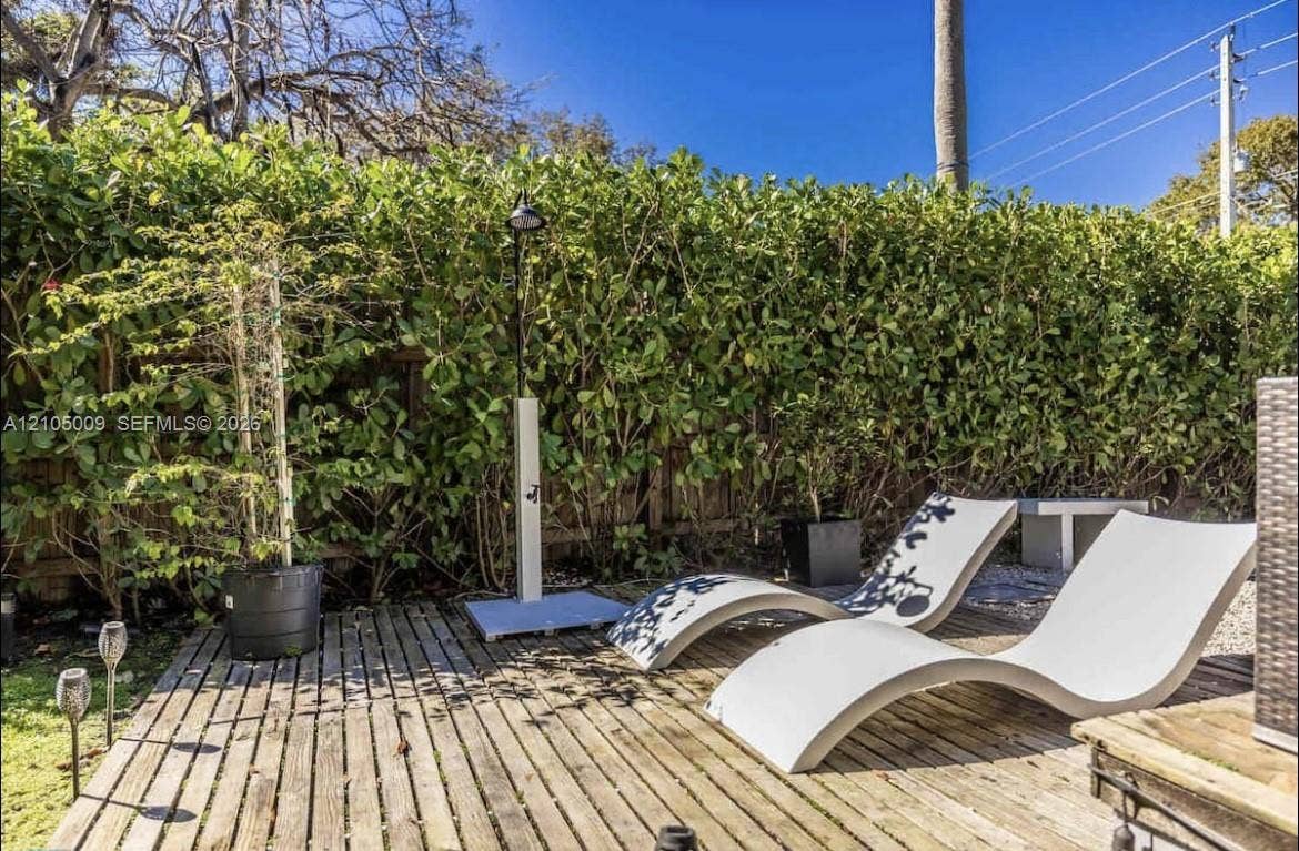 254 NW 51st Street, Miami, Miami, FL 33127 Wood-plank decking with an outdoor shower and lush privacy hedging