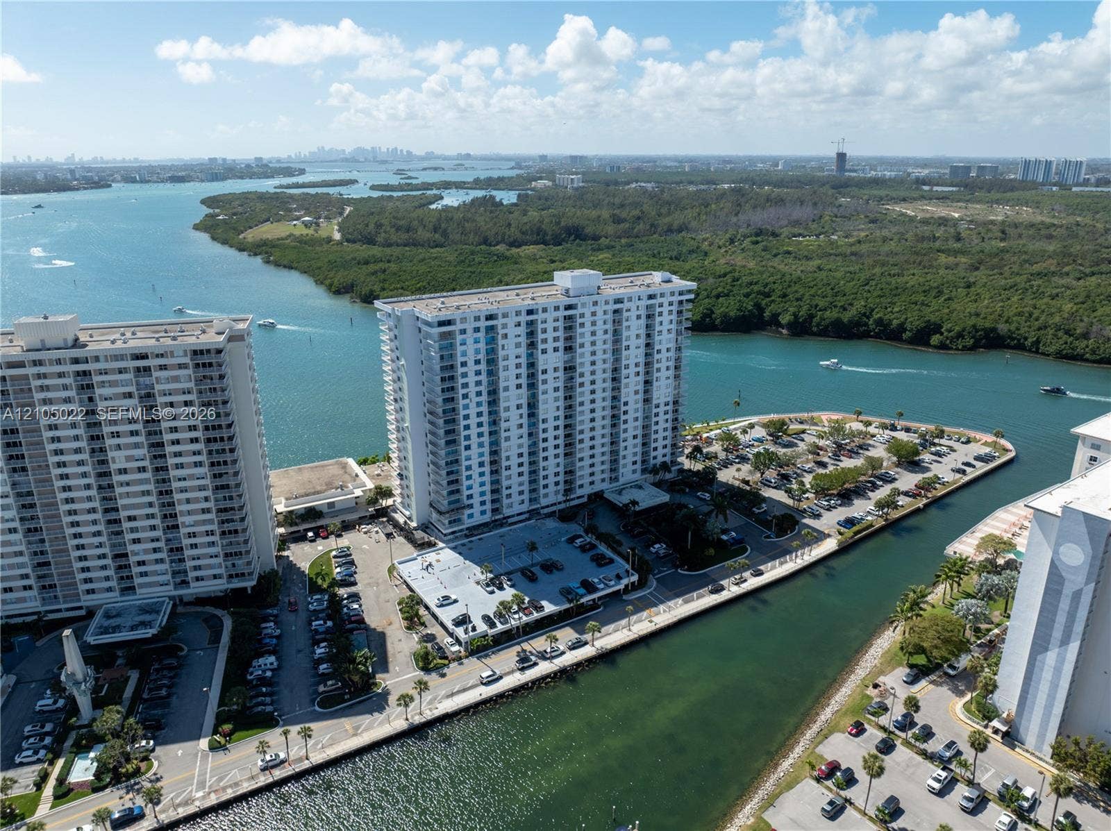 500 Bayview Drive, #1520, Sunny Isles Beach, Sunny Isles Beach, FL 33160 Waterfront property featuring multiple high-rise buildings and expansive surface parking areas