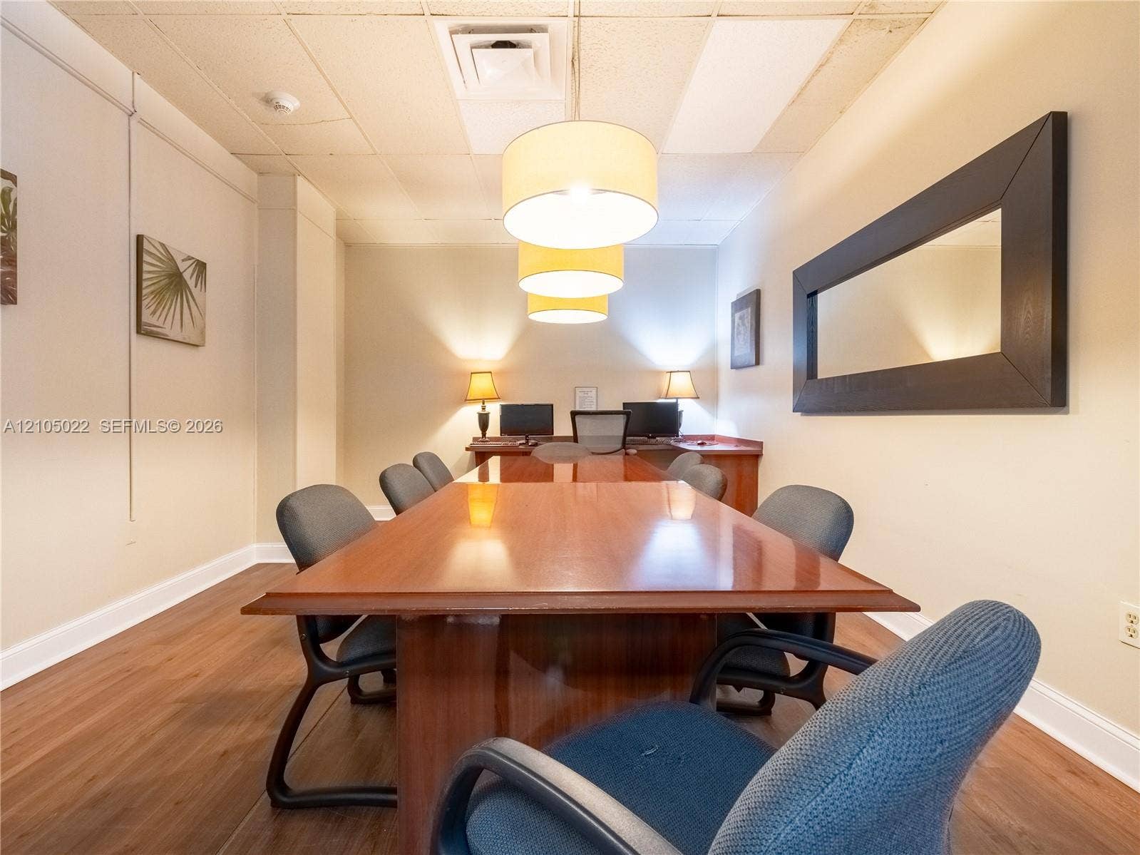 500 Bayview Drive, #1520, Sunny Isles Beach, Sunny Isles Beach, FL 33160 Wood-finish flooring with white baseboards, suspended ceiling with recessed lighting, and a large rectangular mirror with a dark frame