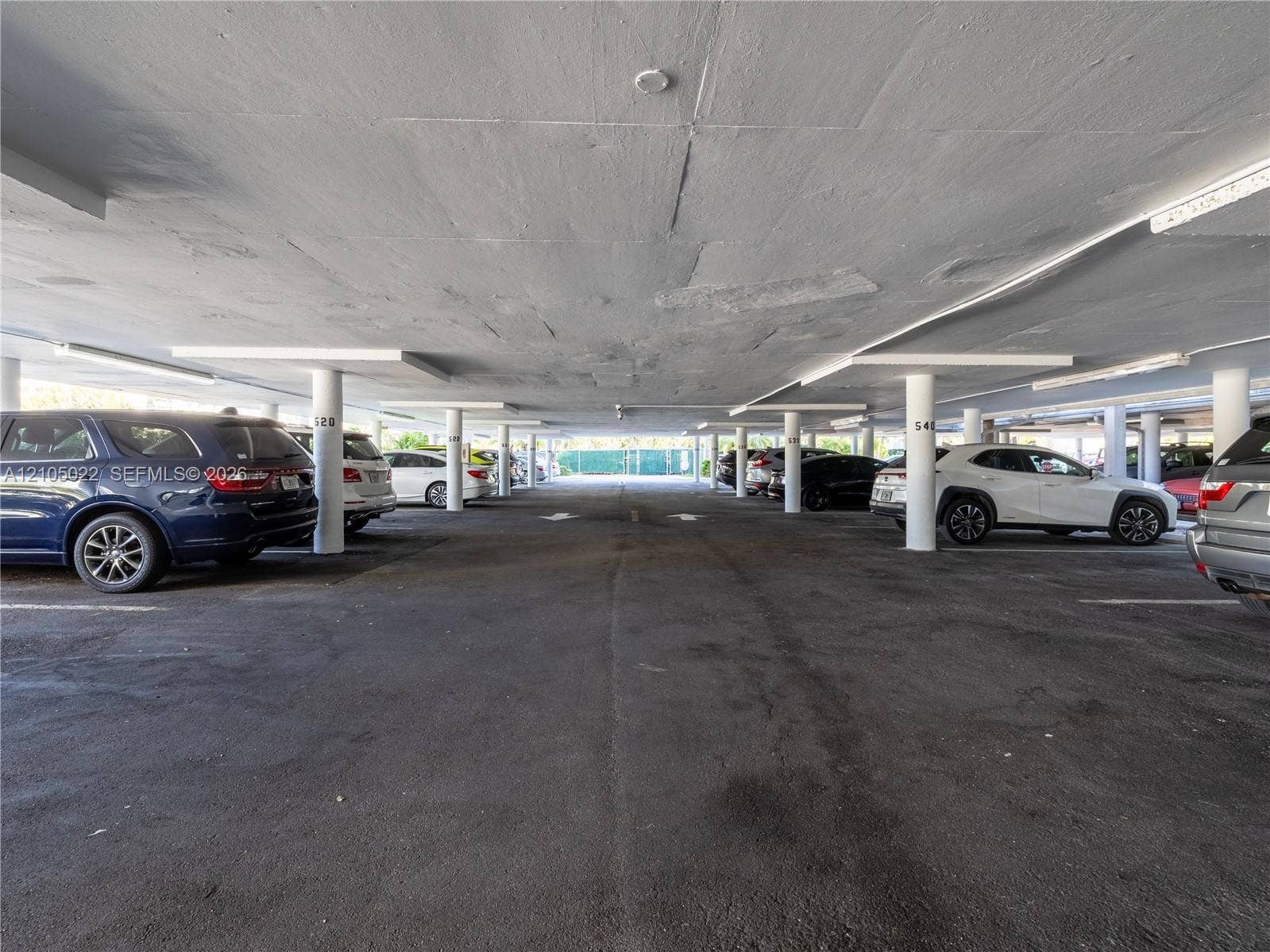500 Bayview Drive, #1520, Sunny Isles Beach, Sunny Isles Beach, FL 33160 Covered parking structure featuring concrete flooring and integrated lighting