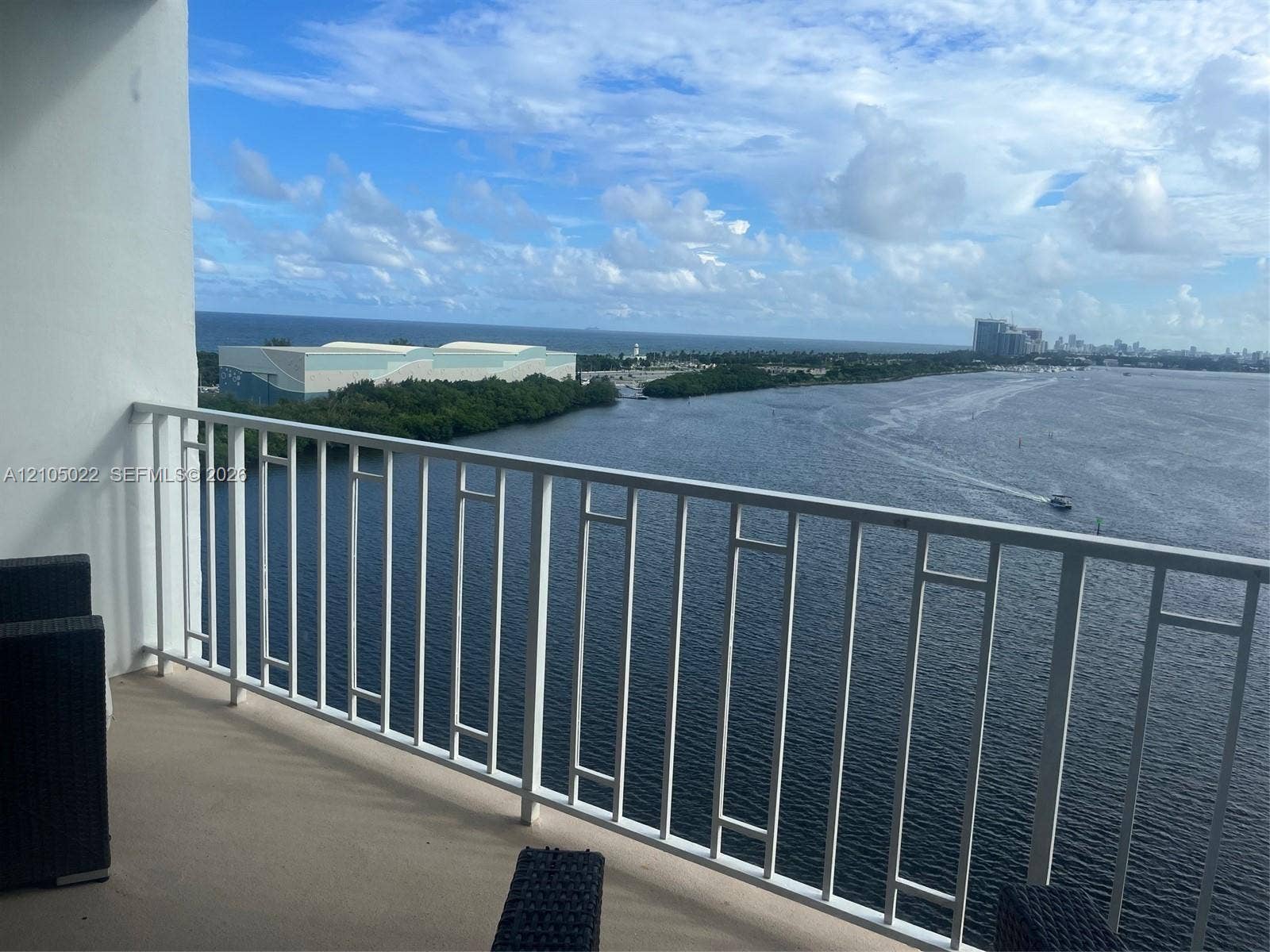 500 Bayview Drive, #1520, Sunny Isles Beach, Sunny Isles Beach, FL 33160 Balcony featuring a white metal railing and a water backdrop with distant buildings
