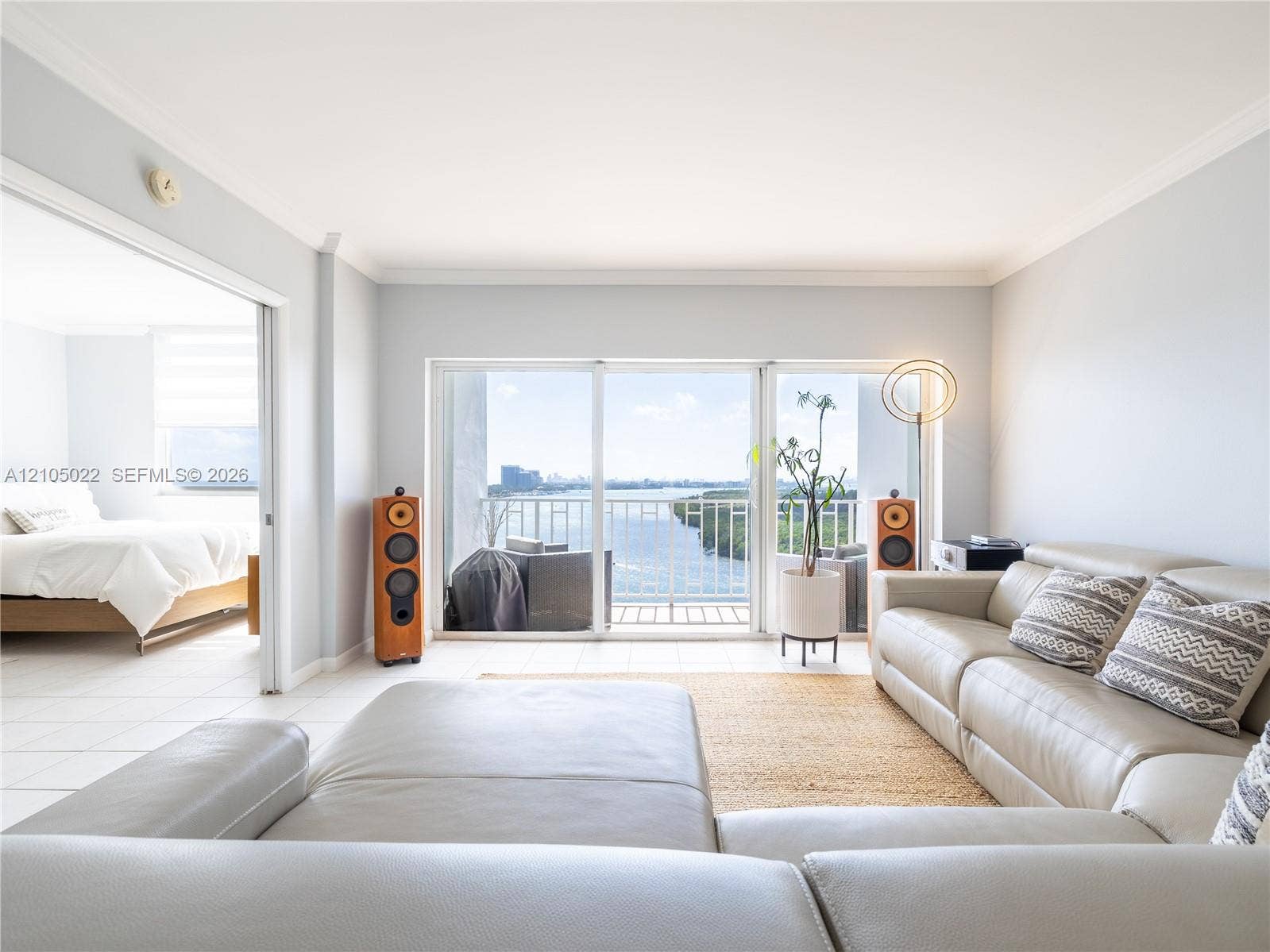 500 Bayview Drive, #1520, Sunny Isles Beach, Sunny Isles Beach, FL 33160 Sliding glass doors leading to a balcony, white tile flooring, and light-colored wall paint