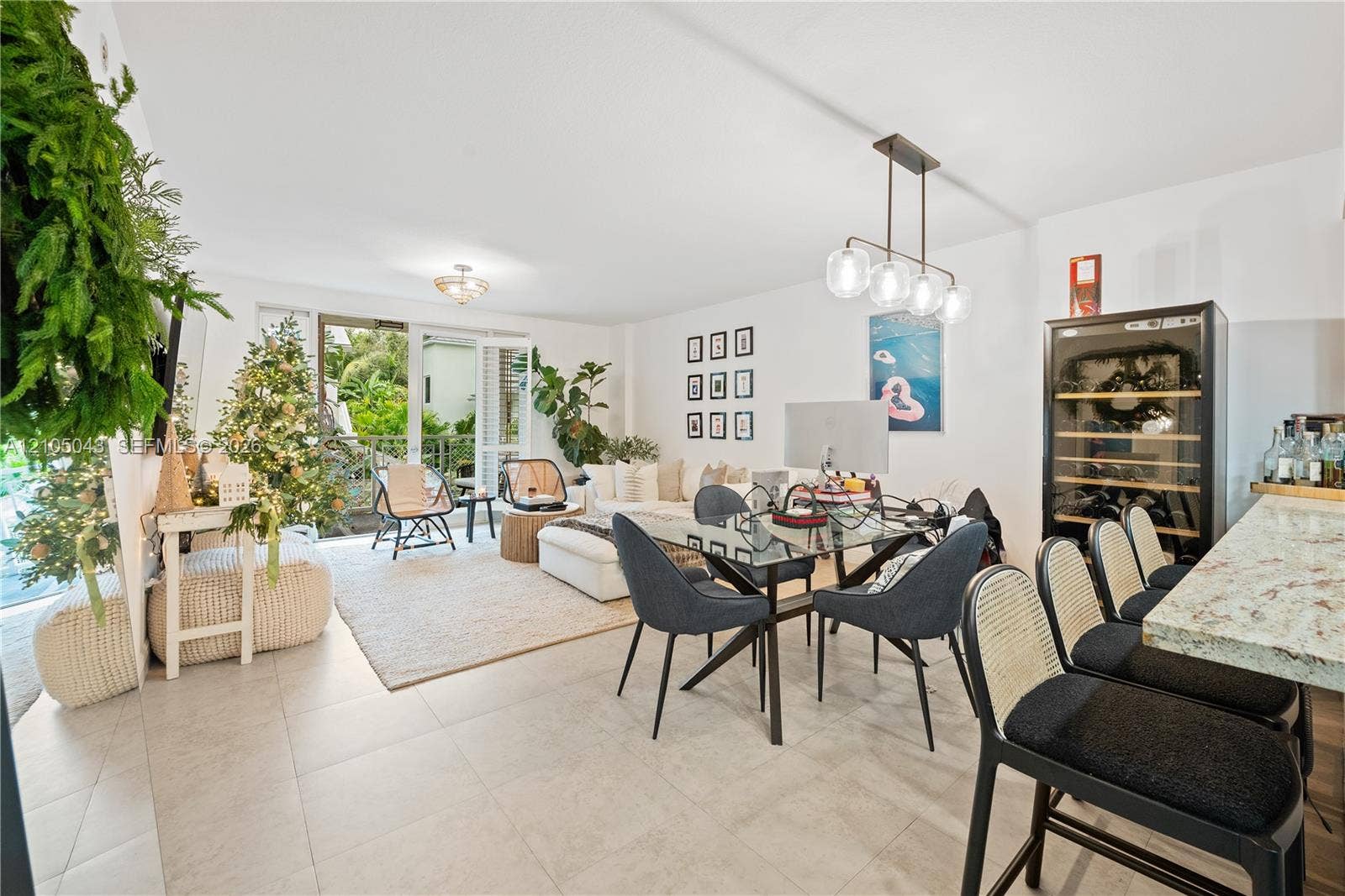 3540 Main Highway, #207, Miami, FL 33133 Kitchen featuring horizontal-slatted cabinetry, light-toned stone countertops, a metallic backsplash, recessed lighting, and tile flooring