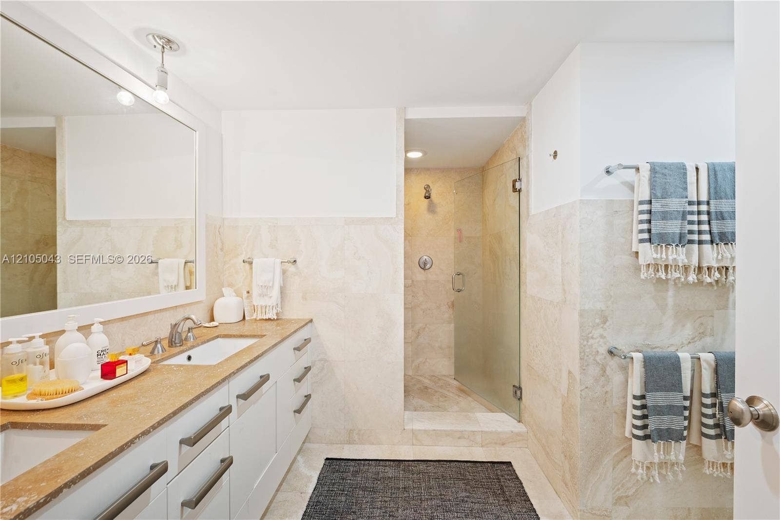 3540 Main Highway, #207, Miami, FL 33133 Interior space featuring white walls, a dual-sconce wall lighting fixture, a multi-bulb ceiling fixture, and plantation shutters