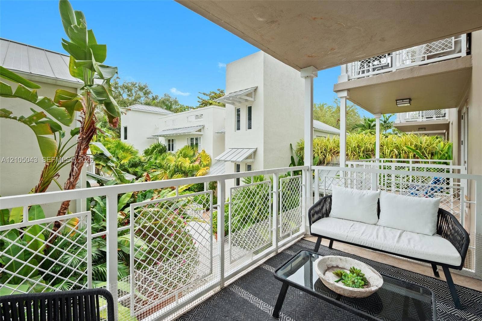 3540 Main Highway, #207, Miami, FL 33133 Kitchen featuring horizontal-grain wood cabinetry, stainless steel professional-grade refrigerator, built-in wall oven and microwave combination, stone countertops, and a stainless steel backsplash