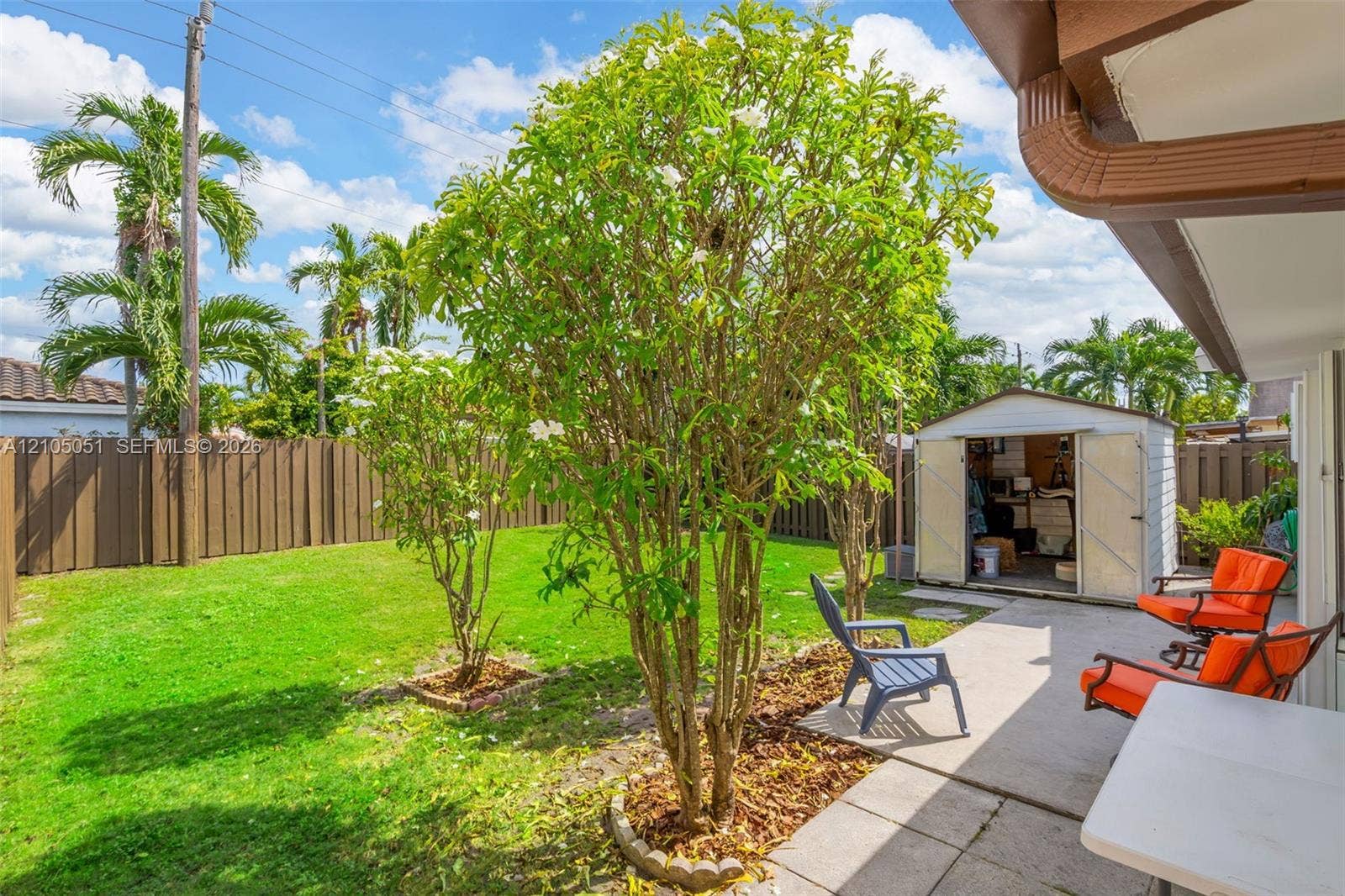 461 SW 89th Court, Miami, FL 33174 Backyard featuring a concrete patio, perimeter privacy fencing, and a detached storage structure