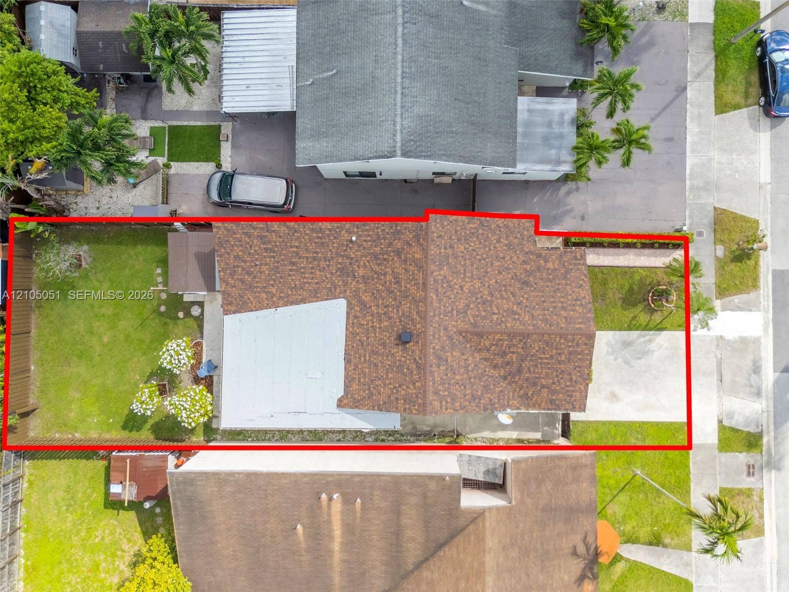 461 SW 89th Court, Miami, FL 33174 Aerial perspective of property lot featuring an expansive backyard, a multi-textured roofline, a private wood fence, and a concrete driveway