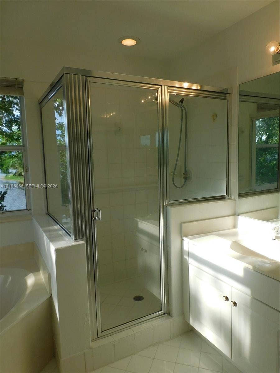 16729 Amber Lake, Weston, FL 33331 Tile flooring with a walk-in shower featuring a glass enclosure