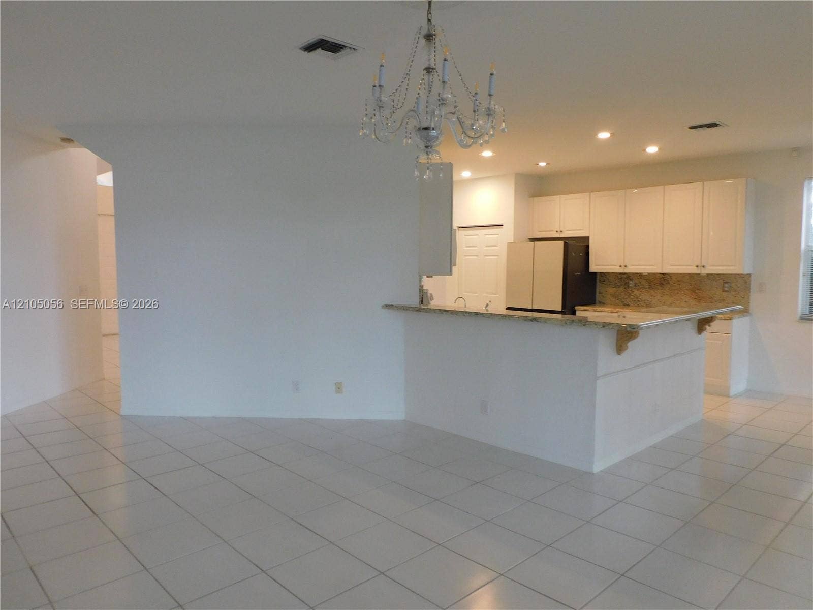 16729 Amber Lake, Weston, FL 33331 Kitchen featuring white cabinetry, granite countertops, and recessed lighting