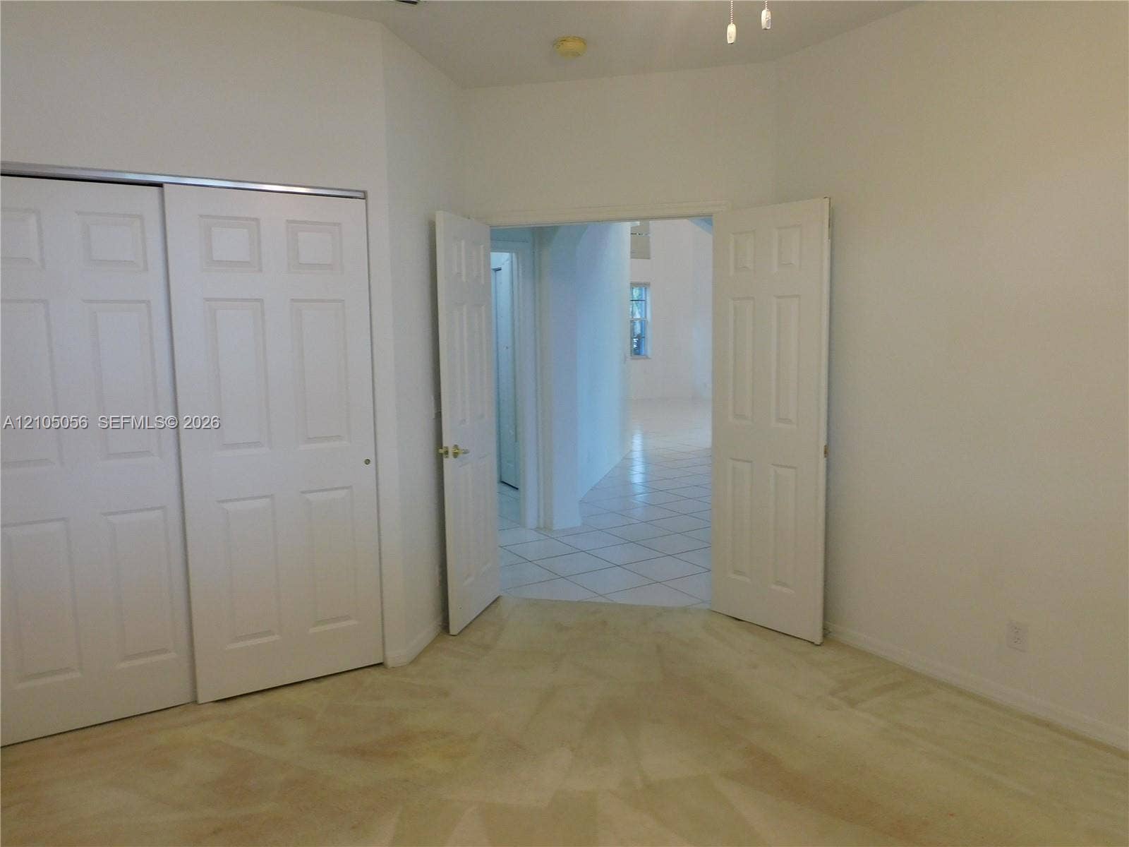 16729 Amber Lake, Weston, FL 33331 Practicability of a full bedroom one bath downstairs, ceiling fan, dual bi-fold panel doors, and double French doors opening to tile flooring