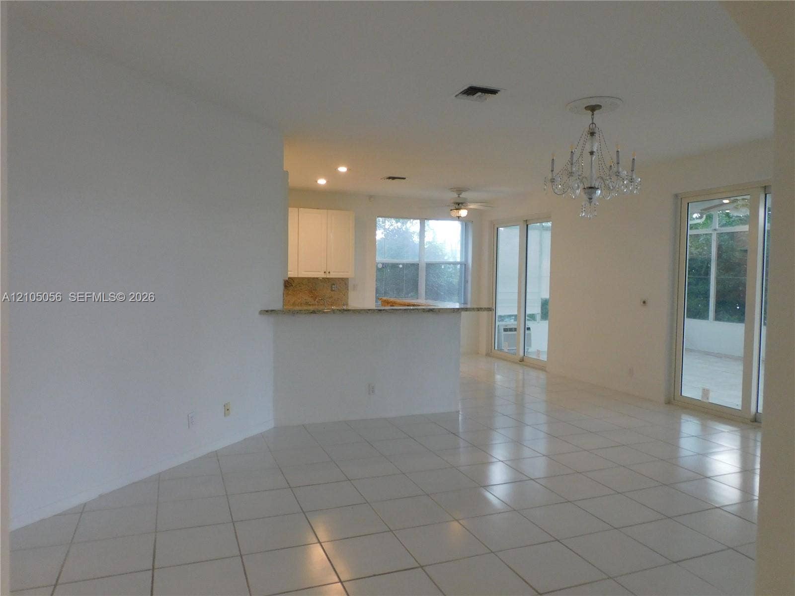 16729 Amber Lake, Weston, FL 33331 Family room view to kitchen snack counter and breakfast area - bringing everybody together + a view to the lake.