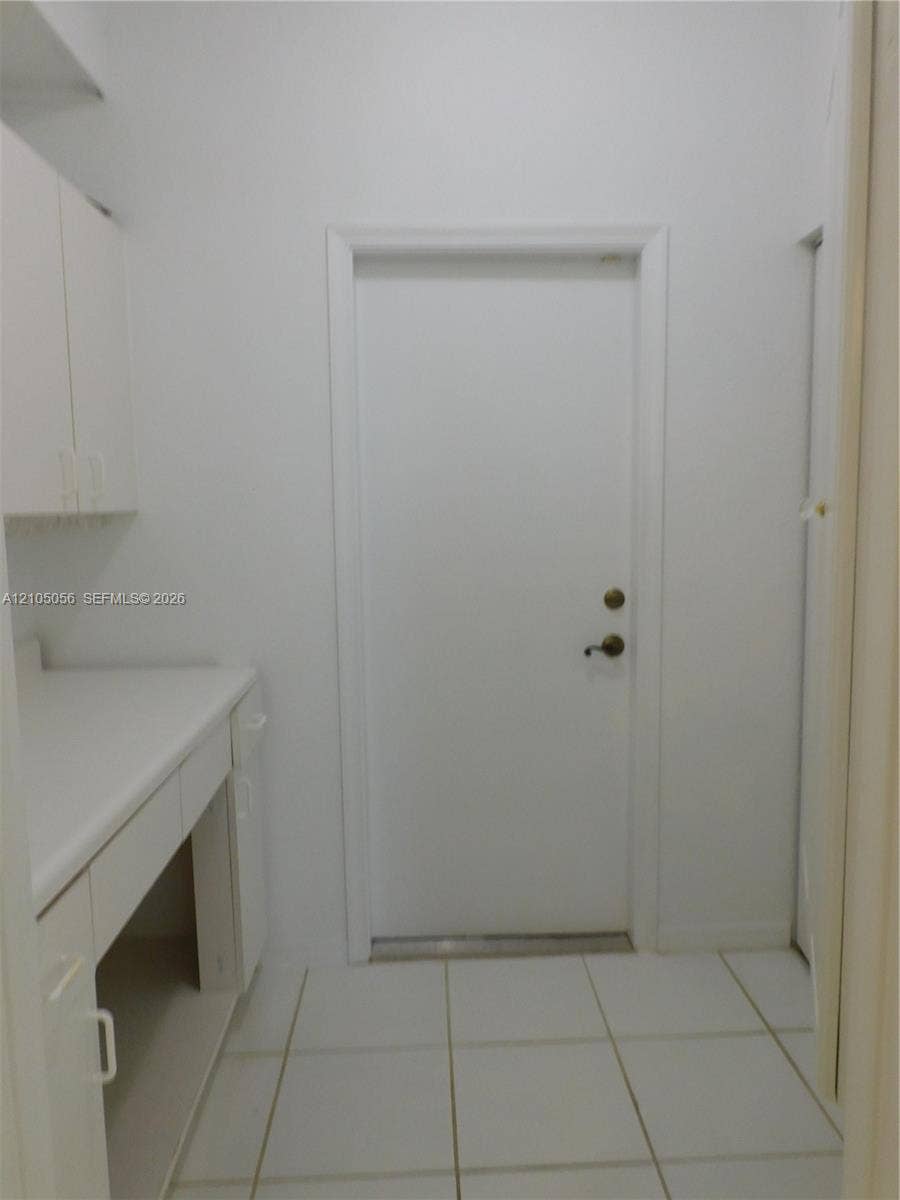 16729 Amber Lake, Weston, FL 33331 Built-in cabinetry with counter space, upper storage, and integrated shelving
