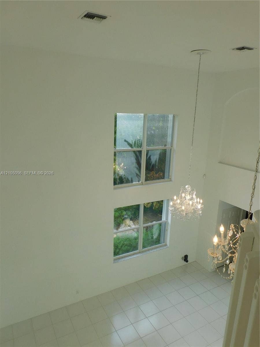 16729 Amber Lake, Weston, FL 33331 View from loft to dining area, two levels of windows, two crystal chandeliers.