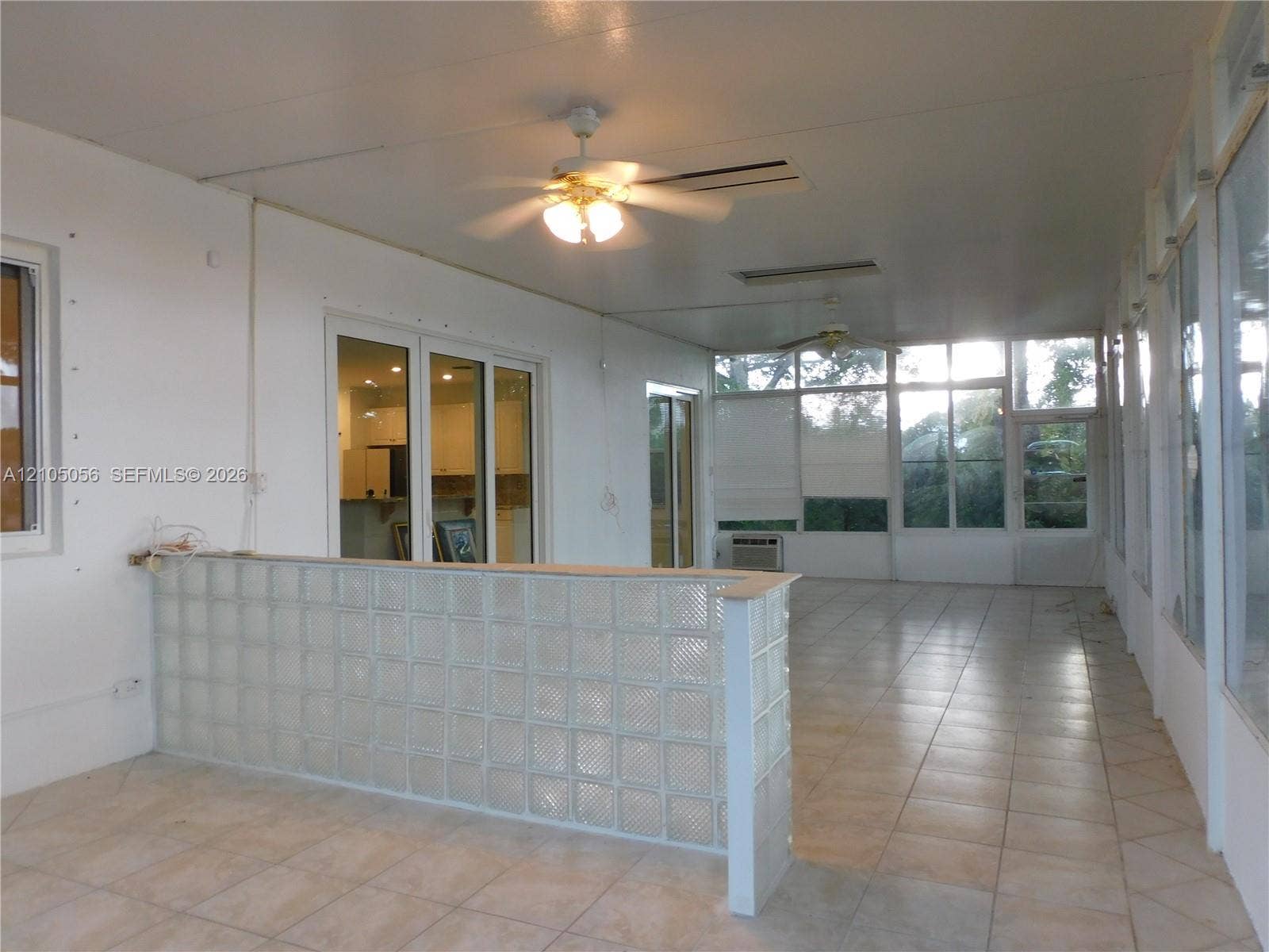 16729 Amber Lake, Weston, FL 33331 Expansive enclosed patio with tiled flooring, multiple ceiling fans, and a glass block bar