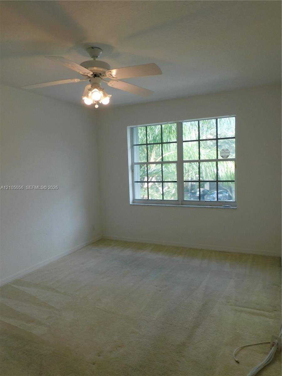 16729 Amber Lake, Weston, FL 33331 2nd Bedroom Window with grid panes and a ceiling fan with integrated lighting