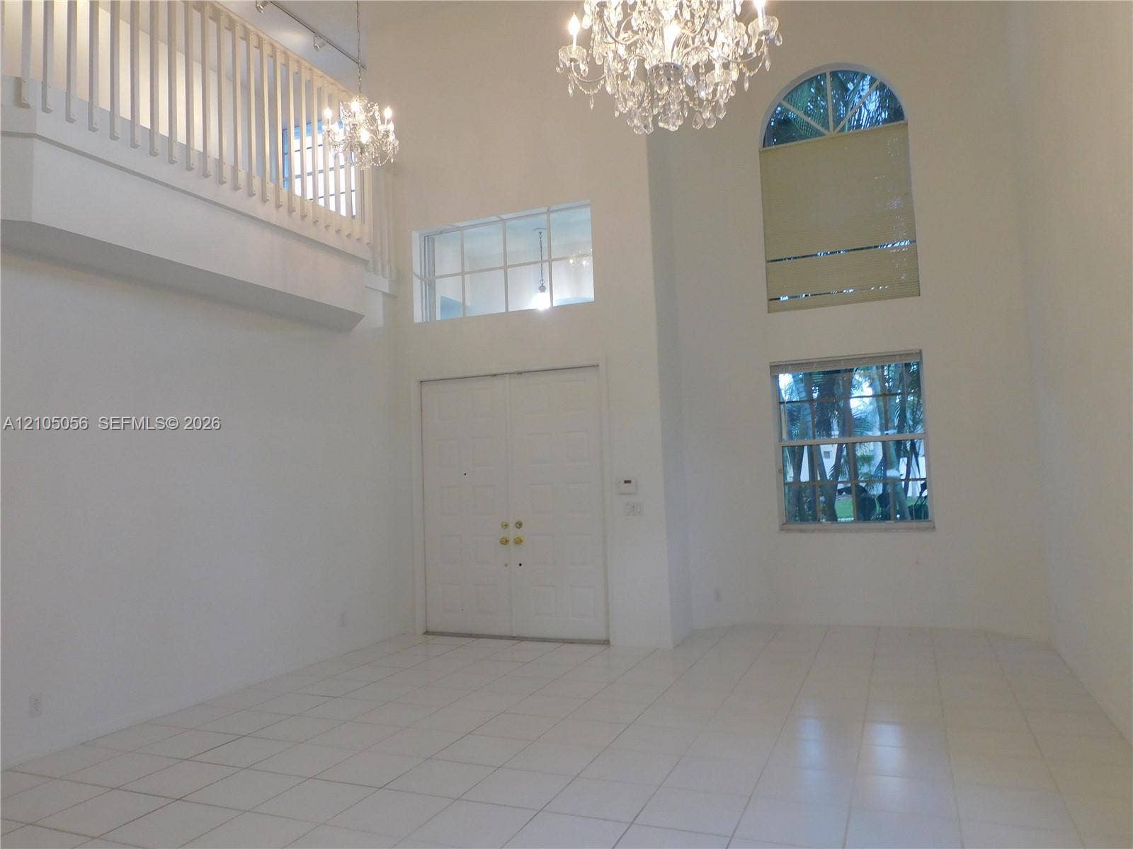 16729 Amber Lake, Weston, FL 33331 Double-door entry, tiled flooring in all social areas, soaring ceilings, arch-top window, and two crystal chandeliers