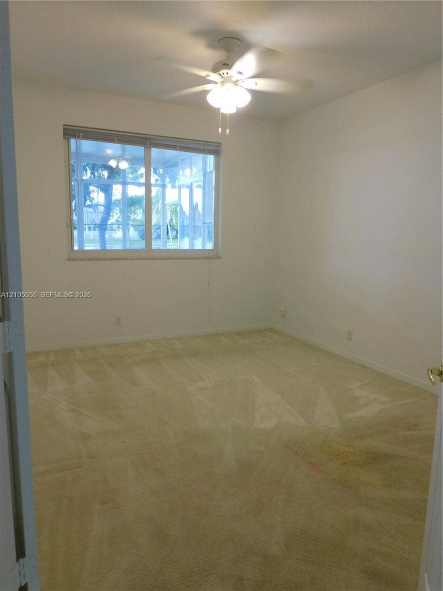 16729 Amber Lake, Weston, FL 33331 Downstairs bedroom with view to Sunroom and lake.