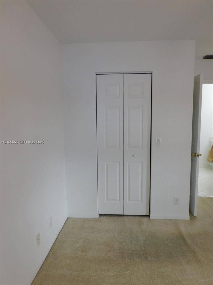 16729 Amber Lake, Weston, FL 33331 Interior space featuring neutral wall tones and bi-fold closet doors