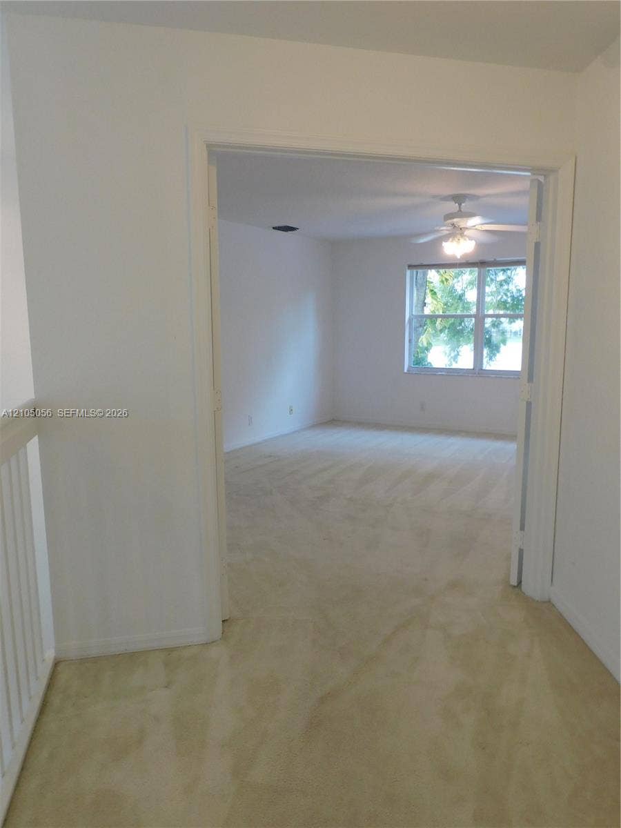 16729 Amber Lake, Weston, FL 33331 Carpeted flooring, white interior walls, white trim, recessed lighting, and a ceiling fan with light fixture